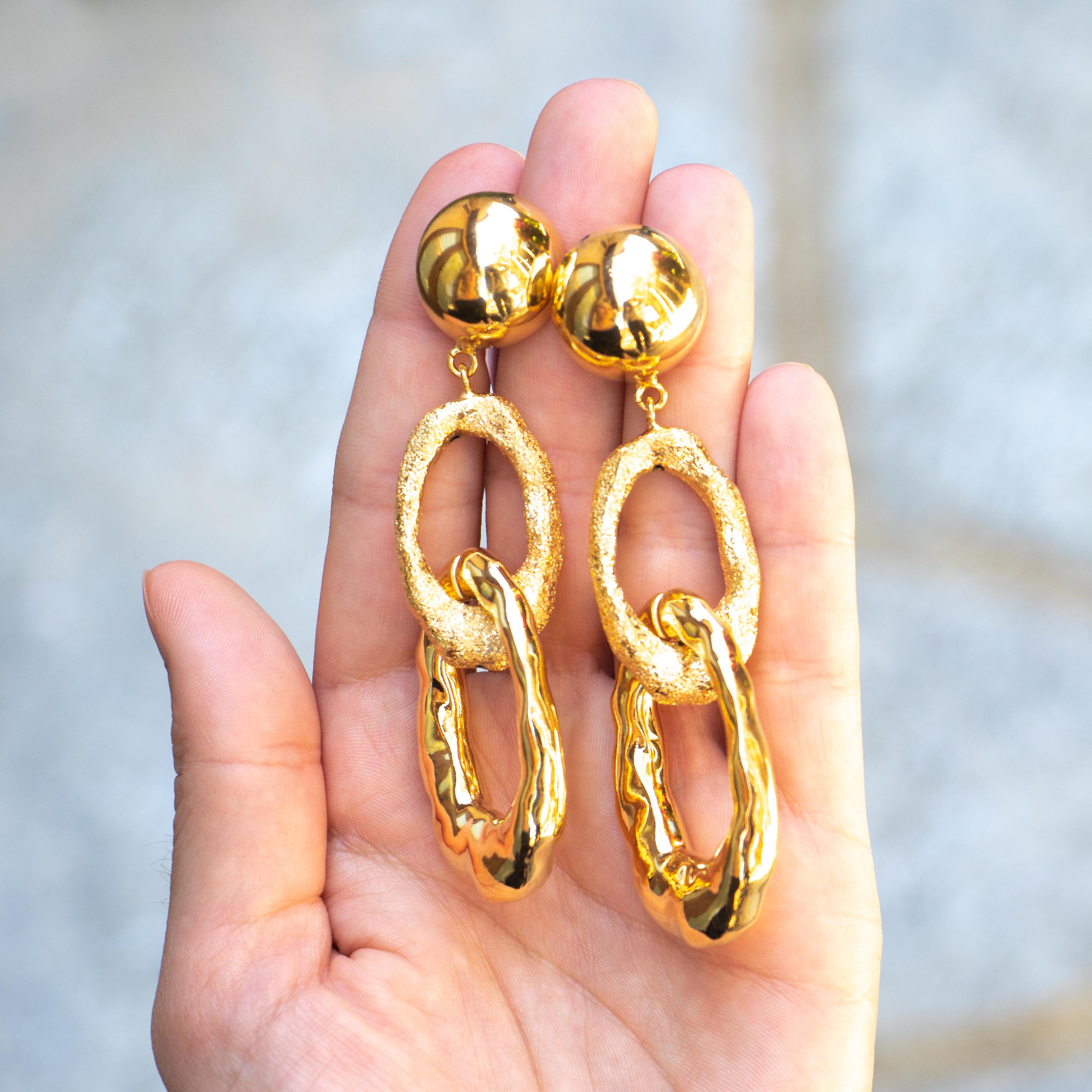 Beautiful dangle earrings featuring one textured hoop and one smooth hoop. 
Designer: Cristina Sabatini 
18K Gold Plated Sterling Silver