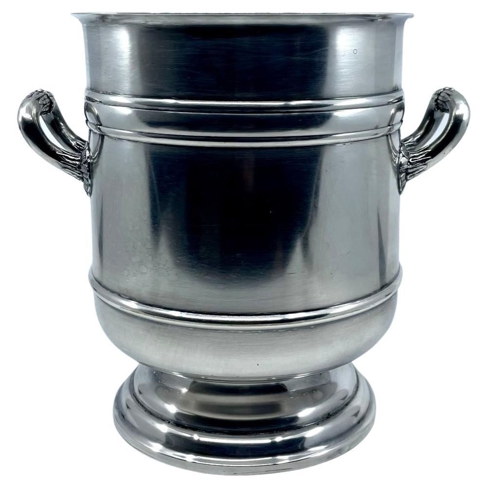 Cristofle silver champagne ice bucket. Neoclassical style hotel silver plate urn form ice bucket with Medici style foliate reed and bead handles. Stamped with silver hallmark and “Christofle FRANCE” France, 20th Century

Dimensions: 9” H x 9.5” wide