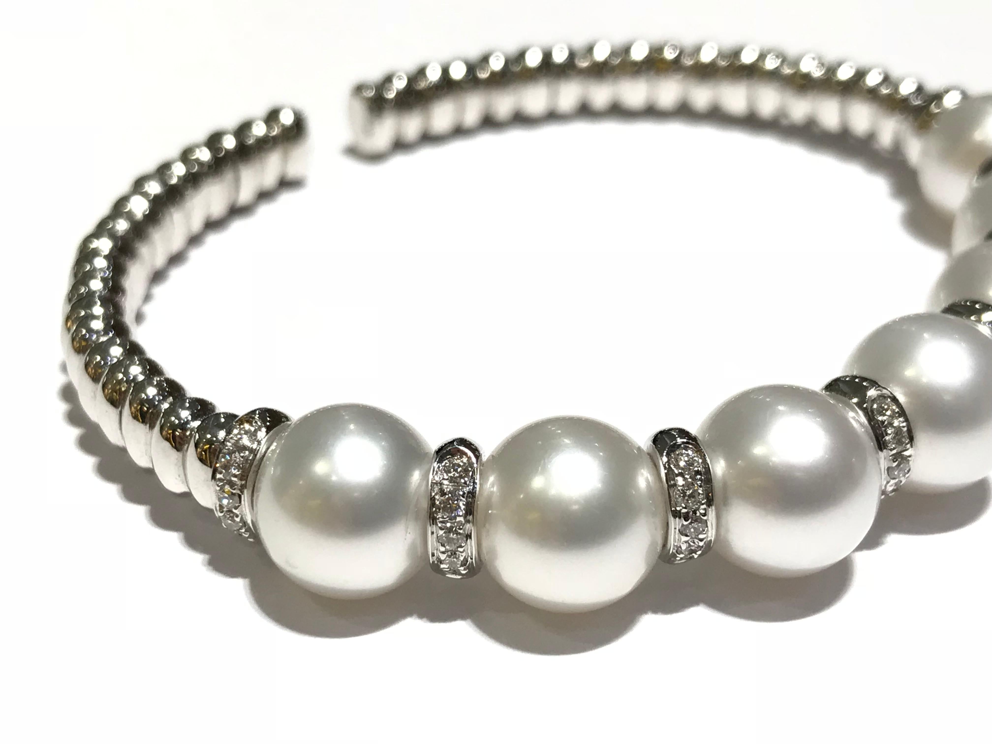CRIVELLI 18 karat white gold bangle with pearls and diamonds 
0.37 ct diamond 
VS clarity F colour 
7 pearls in grey blue tone 