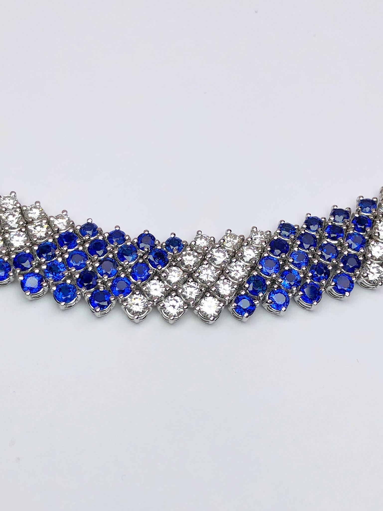 This lovely designed collar necklace by Crivelli is entirely set with 5 rows of round brilliant Diamonds and Blue Sapphires. The alternating stones and the flexibility of the setting will lay beautifully around the neck. The necklace measures 16
