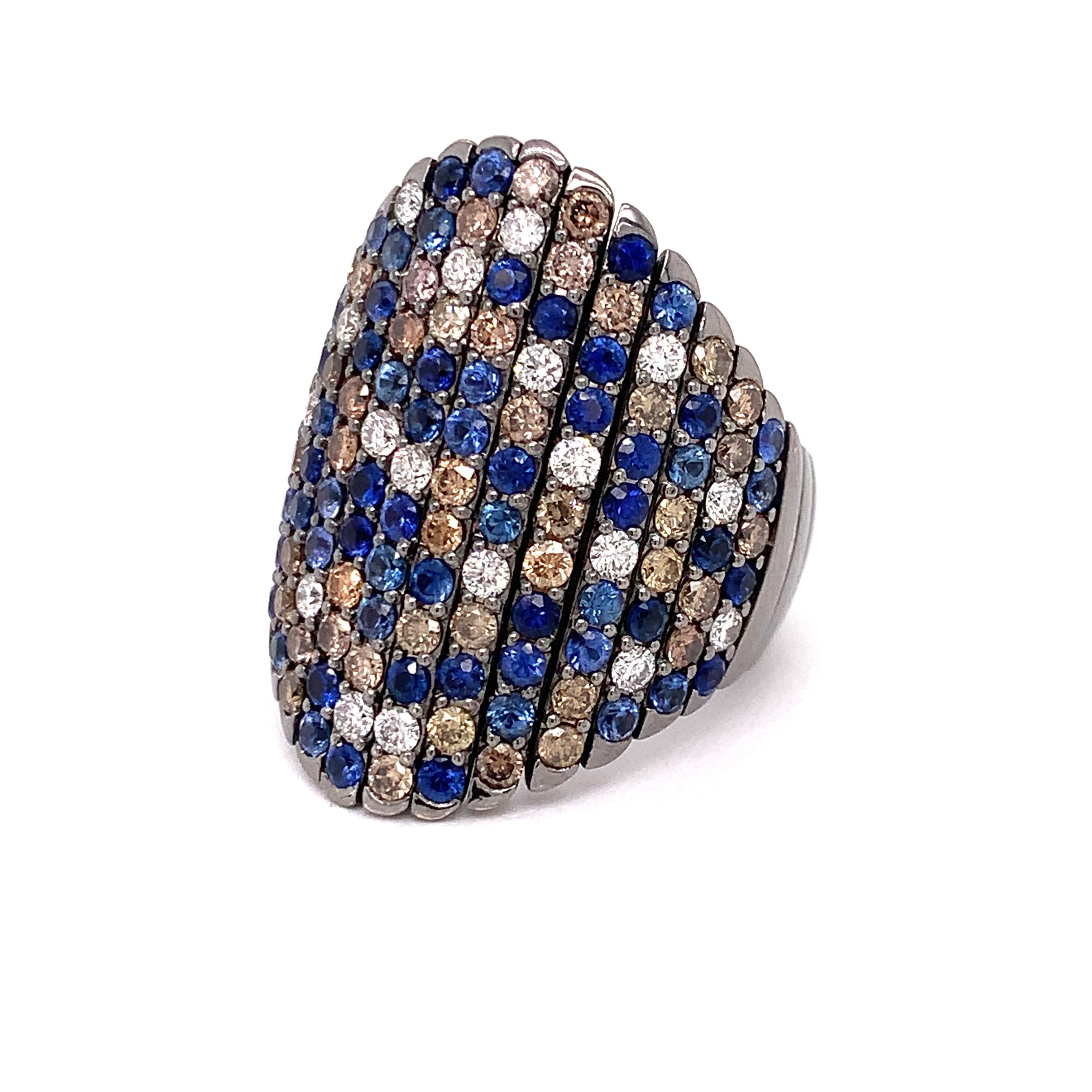 This amazing Crivelli ring checks all the boxes.  Elegant with an array of white and champagne diamonds and blue sapphires.  Sophisticated with black rhodium finish over 18 Kt white gold. Comfortable with a flex band, smooth finish and low profile. 