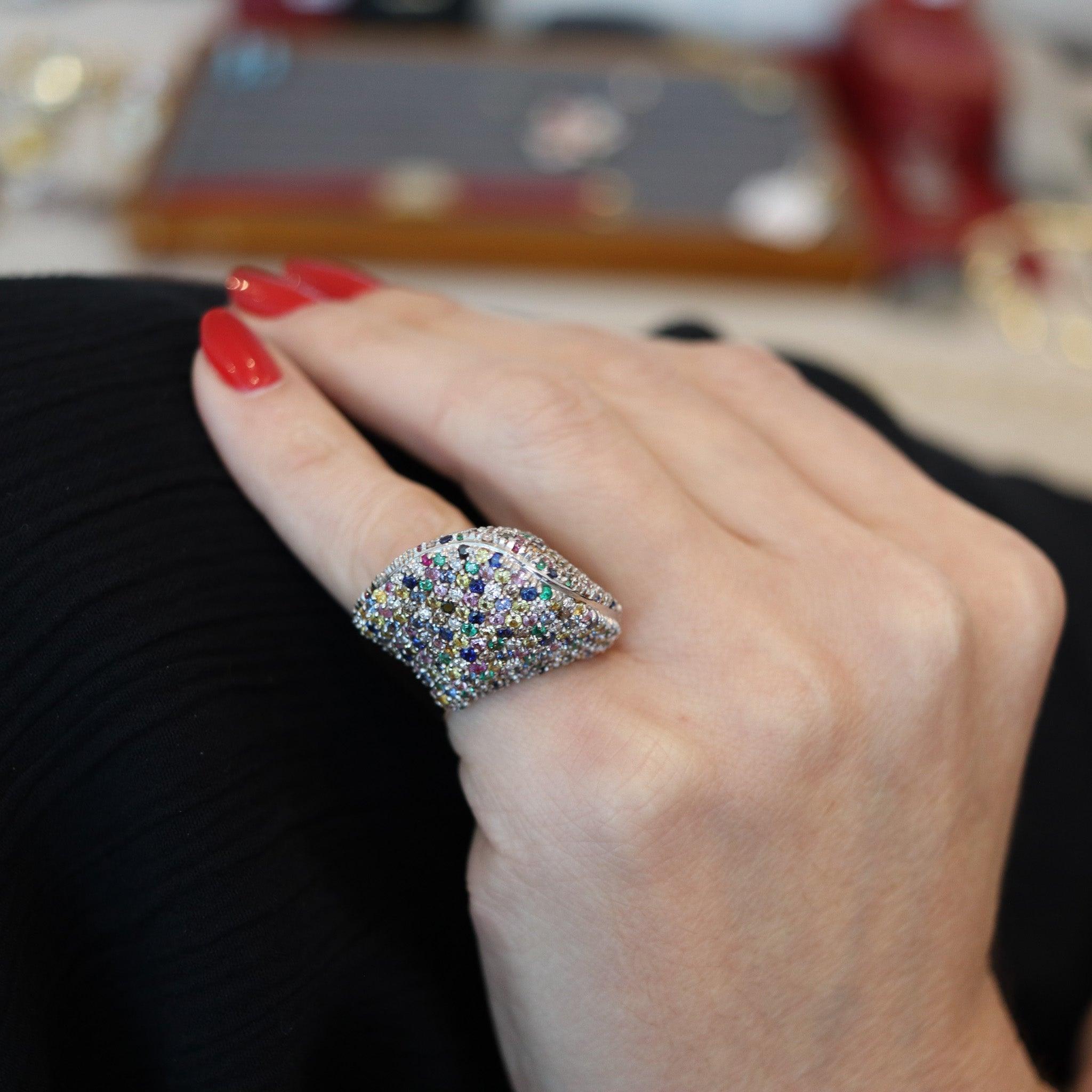 A cluster cocktail ring designed by Crivelli Gioielli.

This is a magnificent colorful cocktail ring, created in Italy by the jewelry house of Crivelli Gioielli. The ring has been masterfully crafted with smooth geometric pyramidal shapes in solid