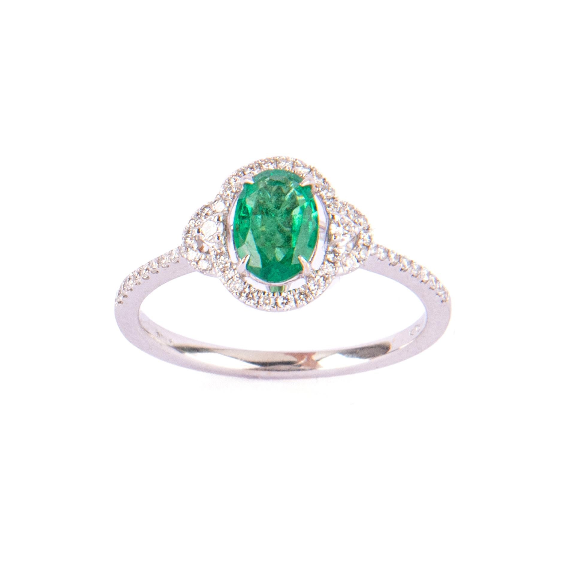 Cute litte emerald ct.0,68 ring, featured with little diamonds ct.0,23. Size 14 Italian.

