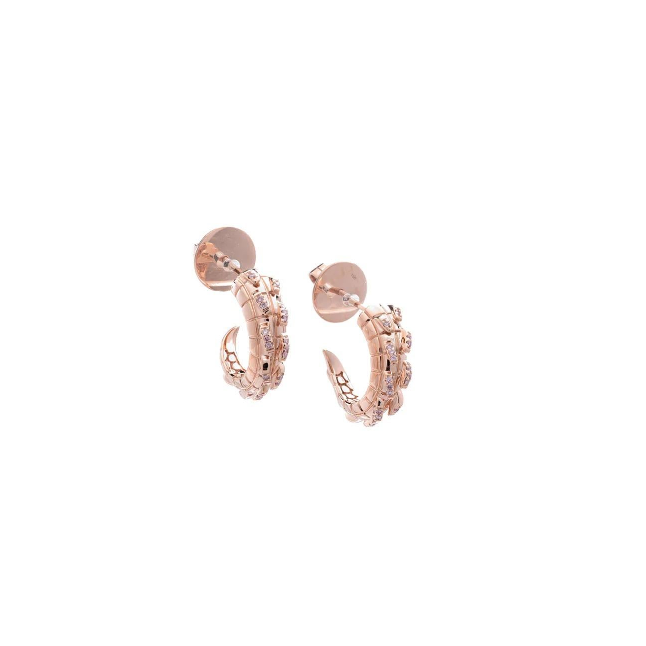 A sophisticated pair of hoops with a fierce edge. Embellished with exquisitely rare Australian Argyle Pink diamonds for an elevated day to night look, these hoops bear all the subtle hallmarks of exceptional craftsmanship. A tapering, spiked tail