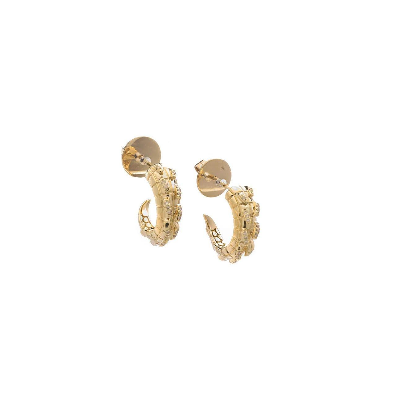 A sophisticated pair of hoops with a fierce edge. Embellished with exquisitely rare yellow diamonds for an elevated day to night look, these hoops bear all the subtle hallmarks of exceptional craftsmanship. A tapering, spiked tail and a subtle croc
