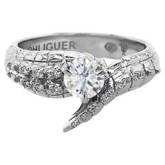 Anello con coda di coccodrillo e diamante rotondo taglio Brilliante in oro bianco 18 ct.