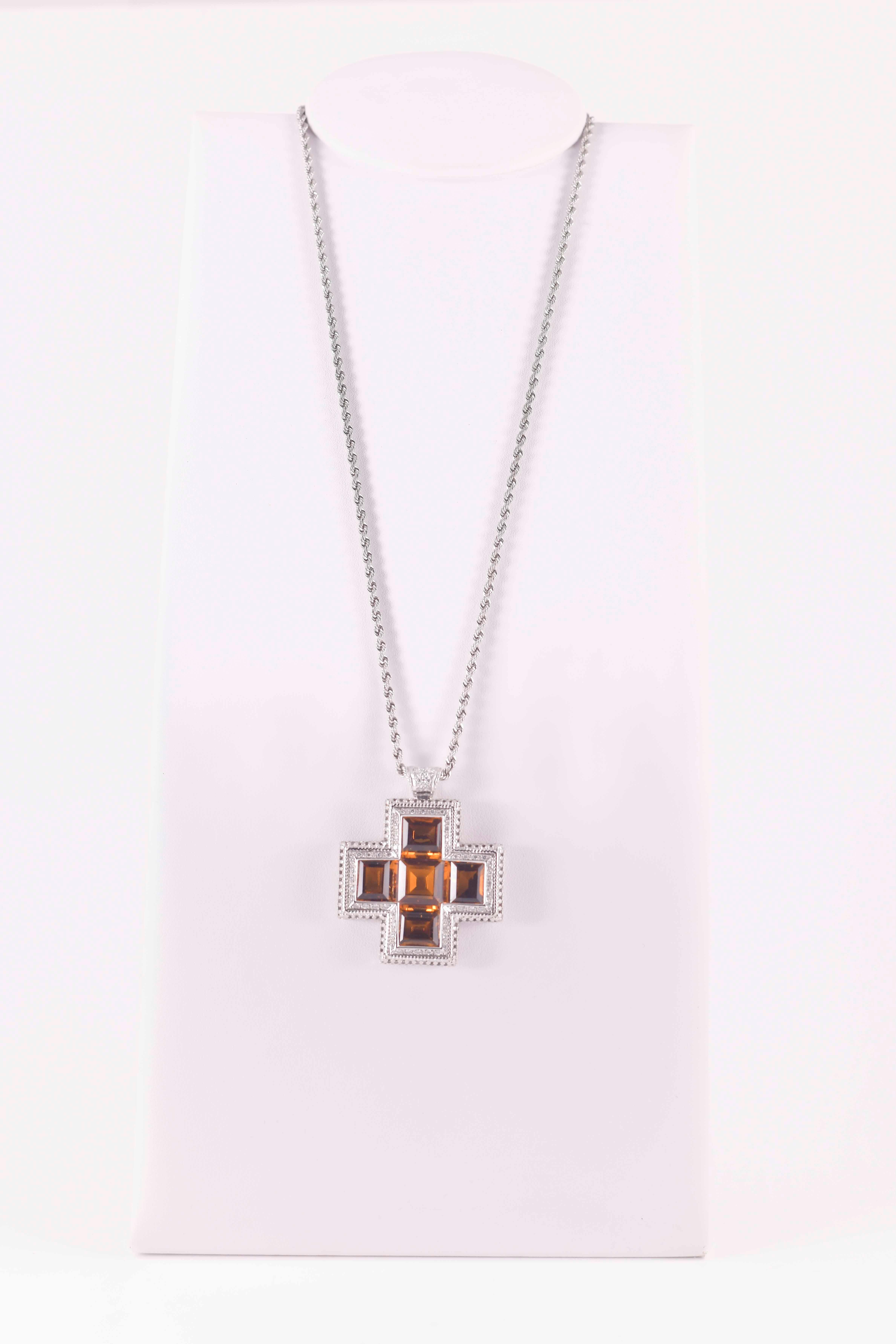 Un simbolo di luce e raffinatezza, questo ciondolo a croce in oro bianco incarna l’equilibrio perfetto tra spiritualità e bellezza. I bracci della croce sono impreziositi da una cascata di diamanti taglio brillante, che catturano ogni riflesso con