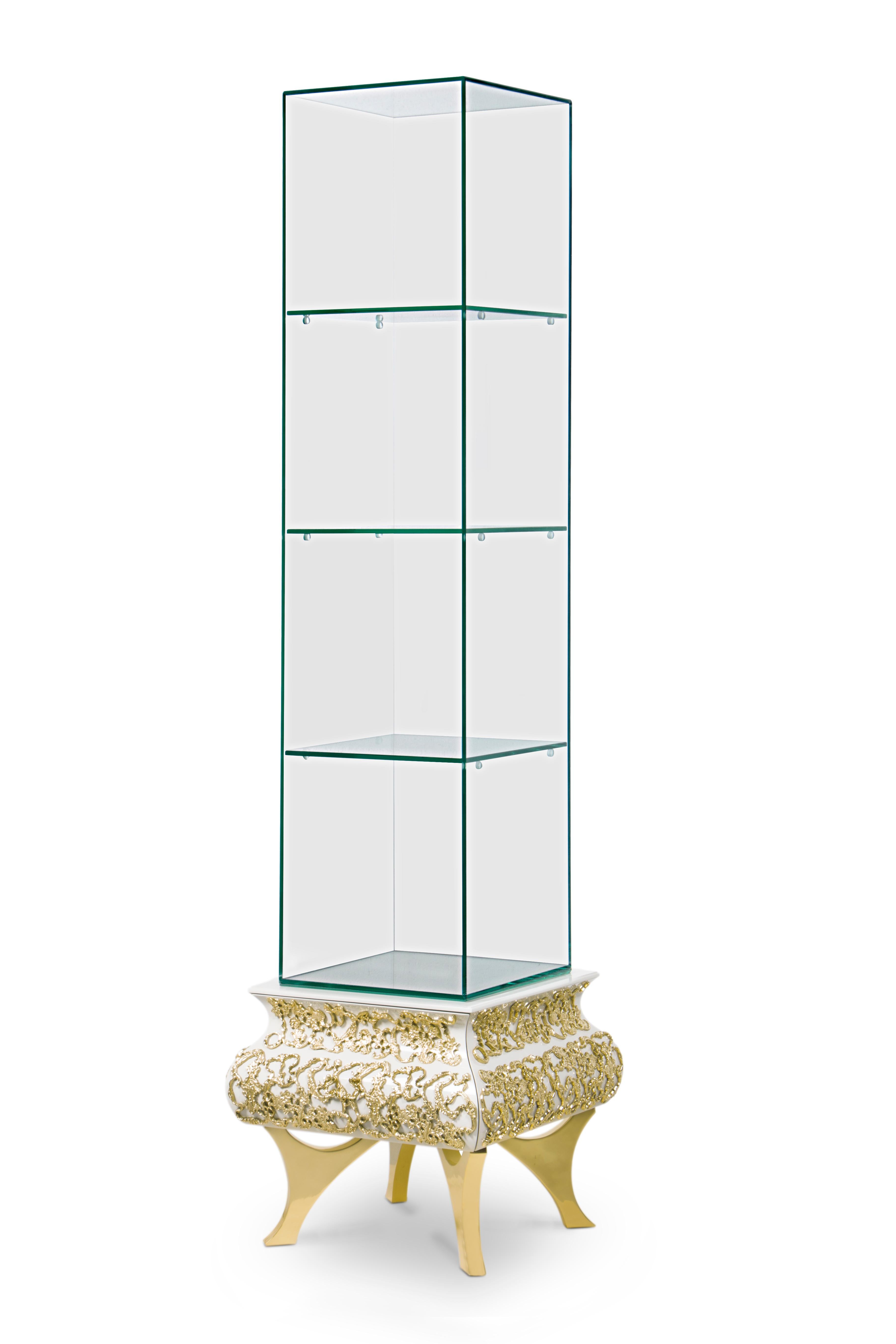 Crochet is a tall display case designed in tempered smoked glass, perfect to exhibit small sculptures, perfumes or other bathroom accessories. This cabinet has 3 shelves and an open back, on top of a wooden structure lacquered in white, accented by