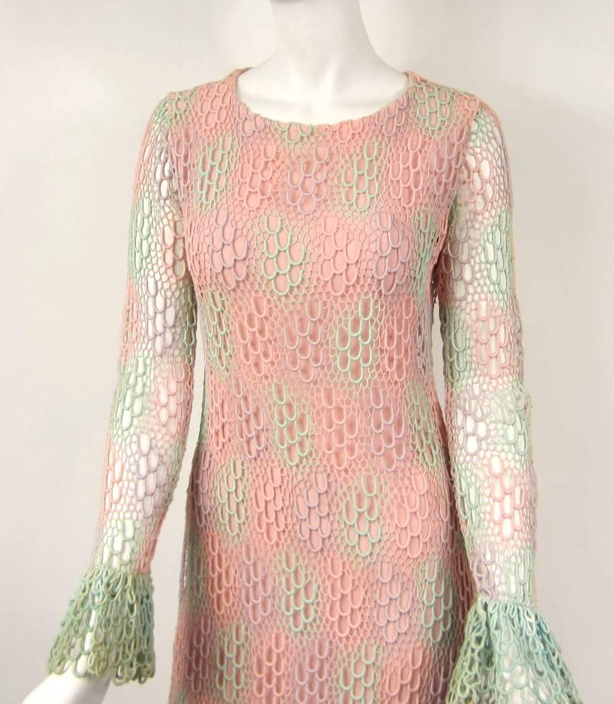 Incredible 1970s vintage Pink and Green crochet maxi dress with Ruffled Cuffs and hem. Zippered up the back. It is fully lined except the sleeves Measuring Up to 35