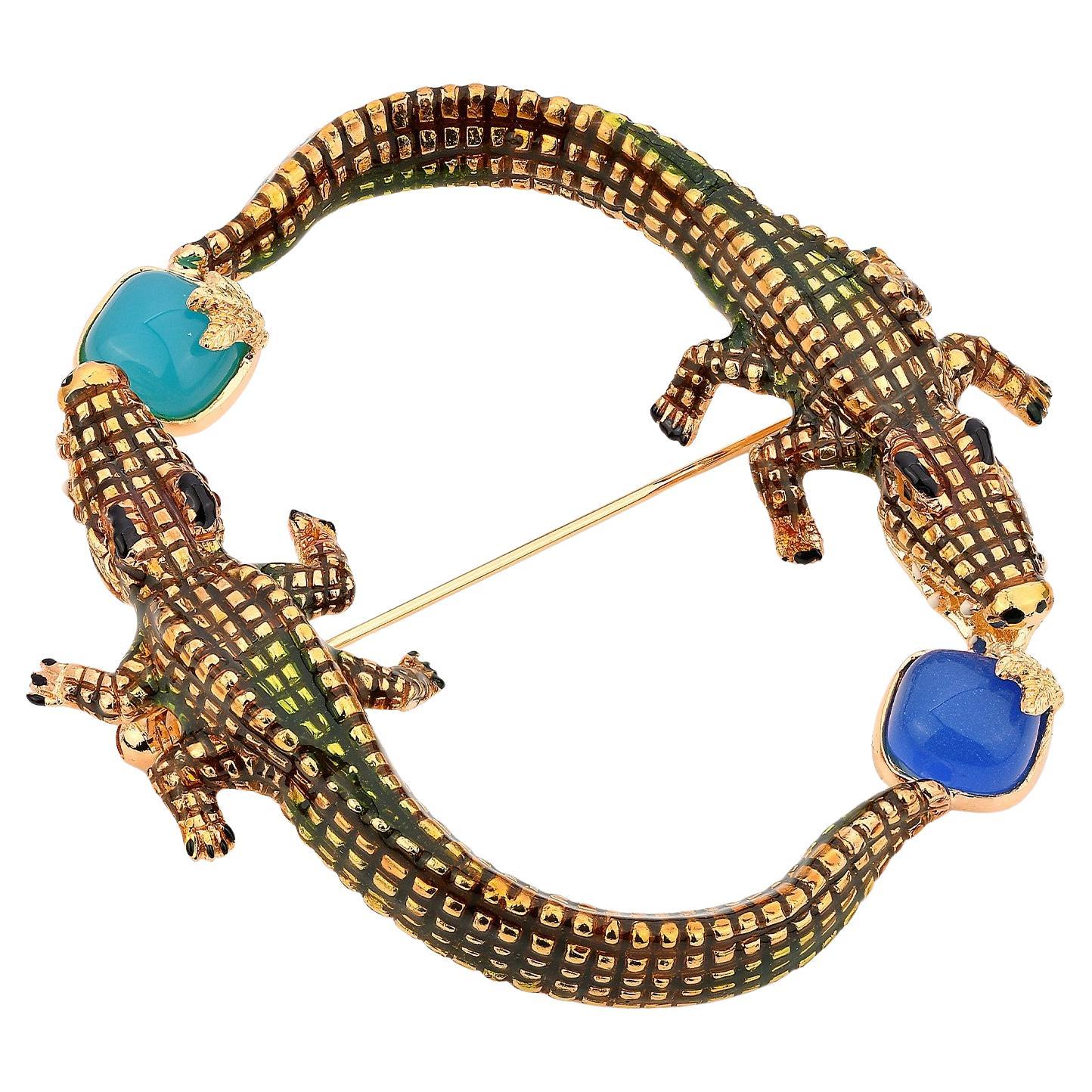 Broche de cocodrilo en pintura esmaltada y creación chapada en oro con piedras azules