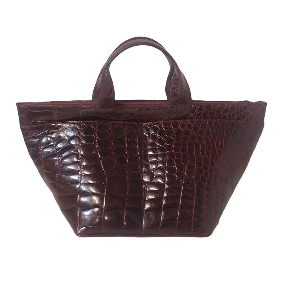 Vintage Real crocodile Burgundy color Two handles Four external pockets One internal zip pocket Additional one pocket Interior suede lining Cm 45 x 24 x 23 (1771 x 944 x 905 inches) Good conditions considering the age
