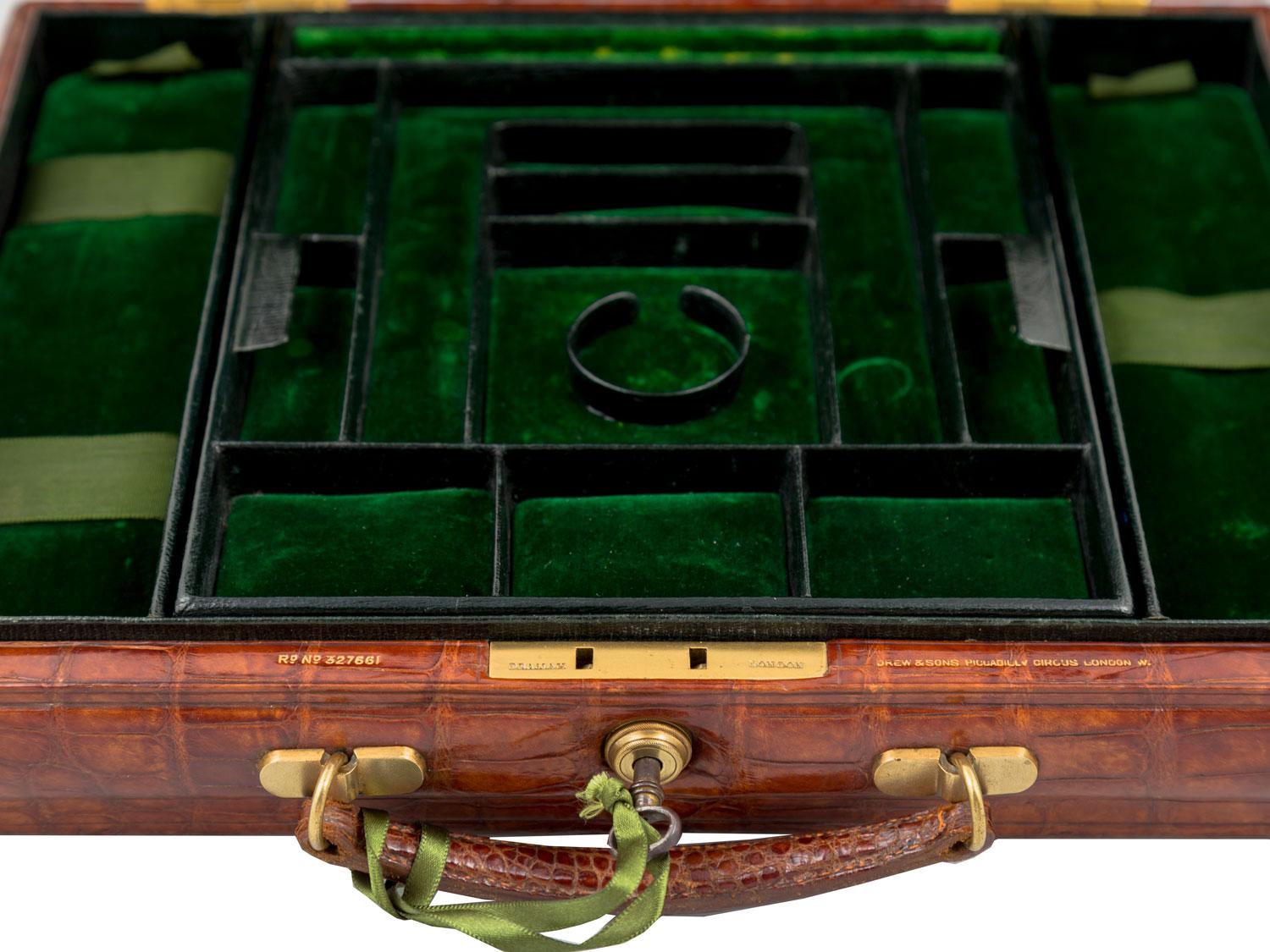 A lovely crocodile jewelry case by Drew & Sons, English circa 1900. Drew & Sons was founded by John Drew and one of his sons, Samuel Drew. The firm began in 1844 and was sold in the 1930s. This jewelry Box is perfect for displaying at home or on the