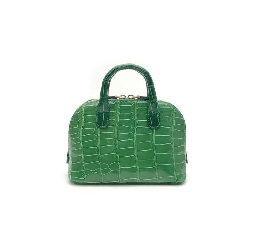 Real crocodile or alligator leather Bright green color Double handle Hand painted sides Internal pocket External pocket Removable shoulder strap Cm 195 x 14 x 85 (7.67 x 5.5 x 3.34 inches) Artisanally made in Milan Italy Comes with CITES