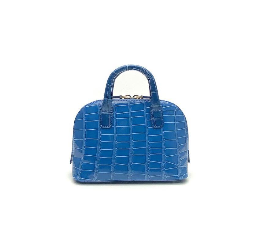 Real crocodile or alligator leather Bright blue color Double handle Hand painted sides Internal pocket External pocket Removable shoulder strap Cm 195 x 14 x 85 (7.67 x 5.5 x 3.34 inches) Artisanally made in Milan Italy Comes with CITES