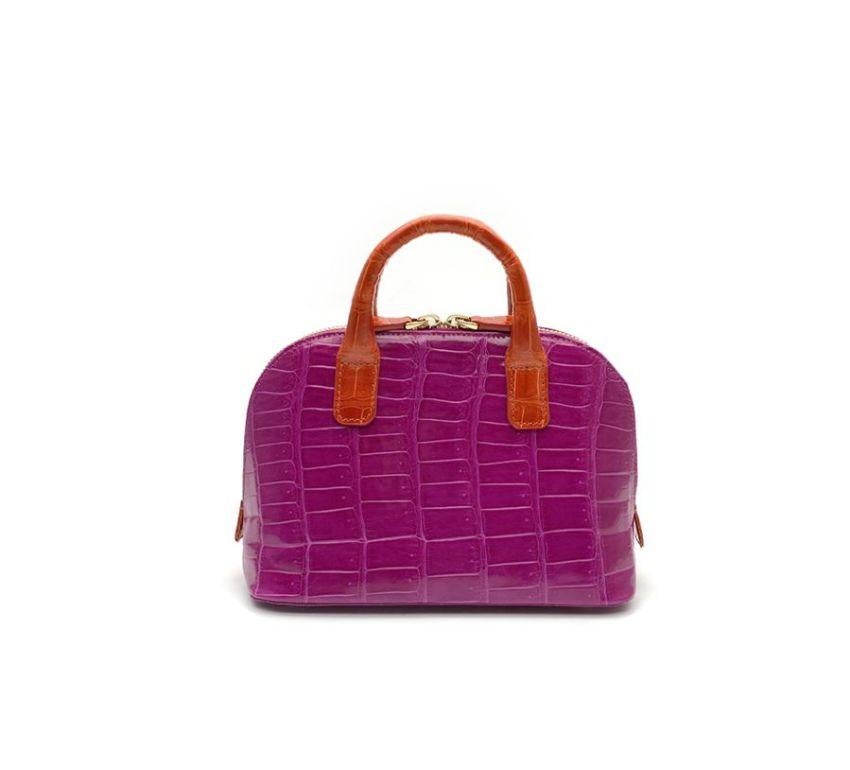 Real crocodile or alligator leather Red and fuchsia color Double handle Hand painted sides Internal pocket External pocket Removable shoulder strap Cm 195 x 14 x 85 (7.67 x 5.5 x 3.34 inches) Artisanally made in Milan Italy Comes with CITES
