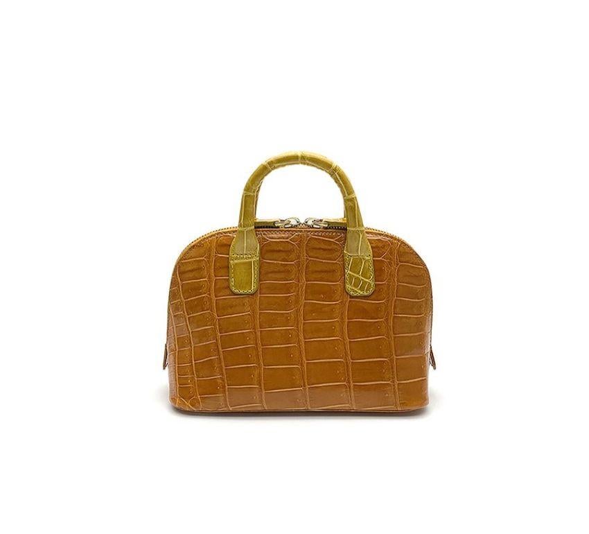 Real crocodile or alligator leather Yellow and orange color Double handle Hand painted sides Internal pocket External pocket Removable shoulder strap Cm 195 x 14 x 85 (7.67 x 5.5 x 3.34 inches) Artisanally made in Milan Italy Comes with CITES