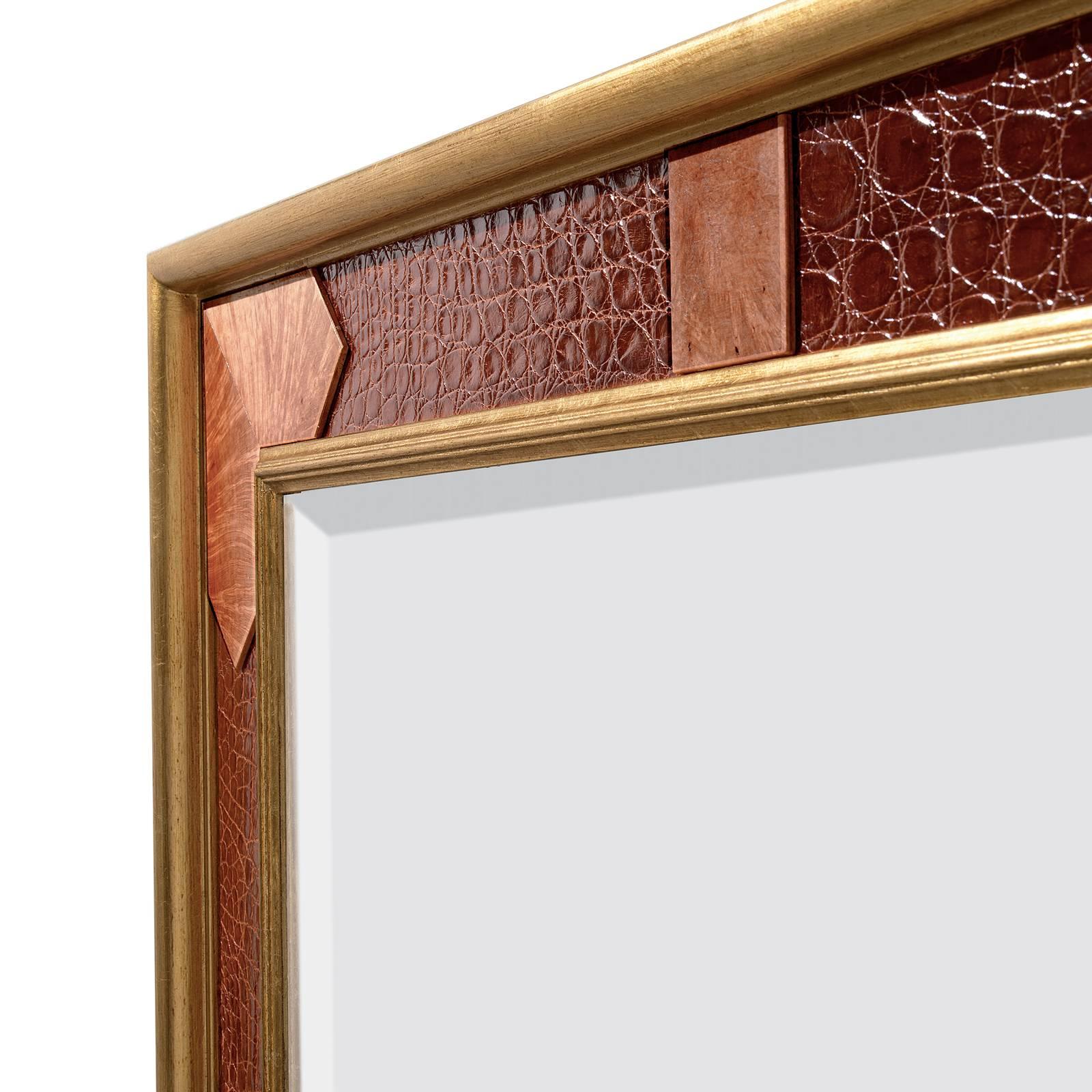 Stunning and sumptuous, this mirror will make a sophisticated statement in both a classic and a contemporary decor, thanks to its exquisite craftsmanship and the use of high-quality materials. The back in mahogany support the mirror with moldings at