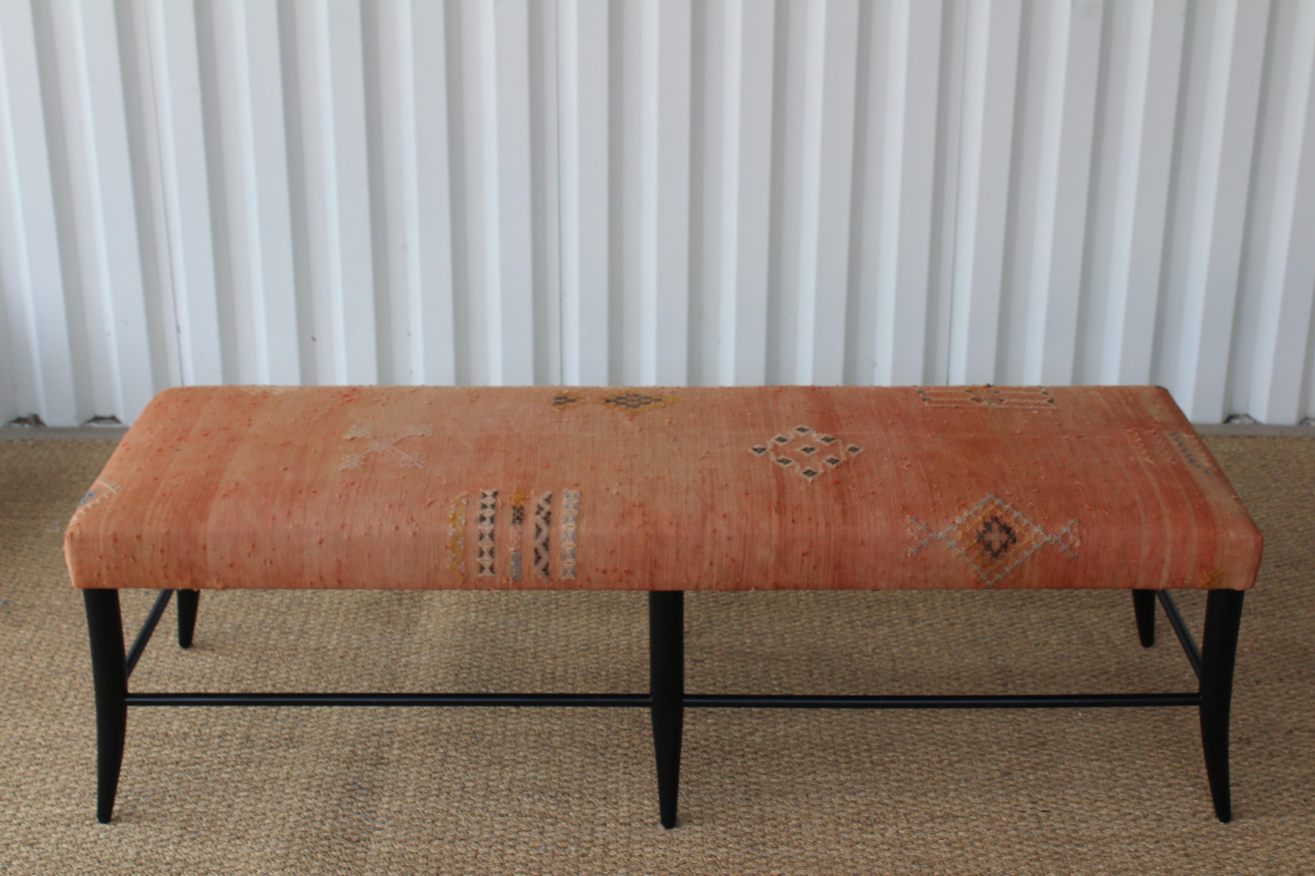 Custom made Croft bench, upholstered in a vintage Turkish textile. Handcrafted in Los Angeles. Wood base has satin black finish. In overall excellent condition. Rug shows age appropriate wear.