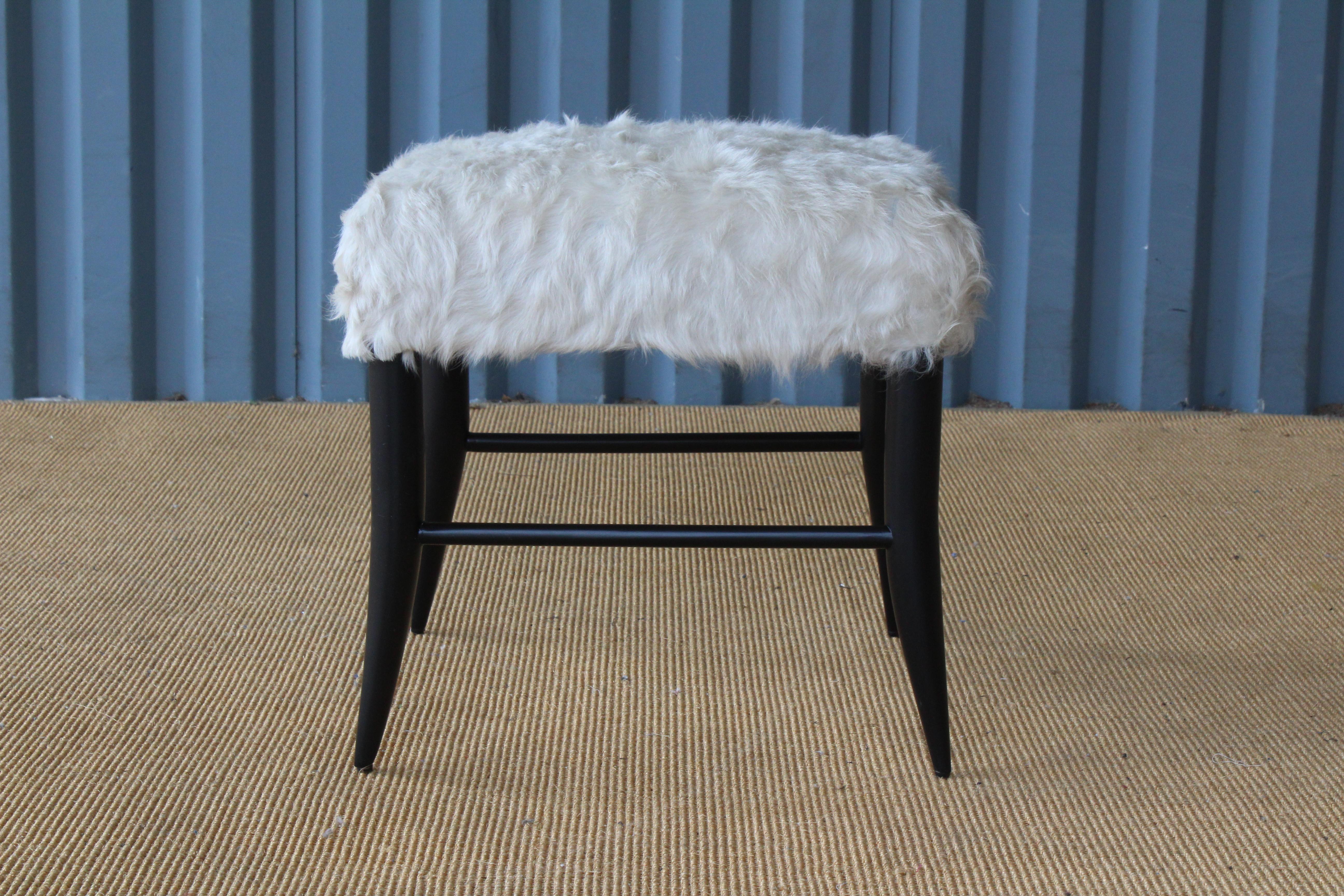 Custom made croft stools by Hollywood at Home. Ebonized base with an upholstered seat in white cowhide. Sold individually.