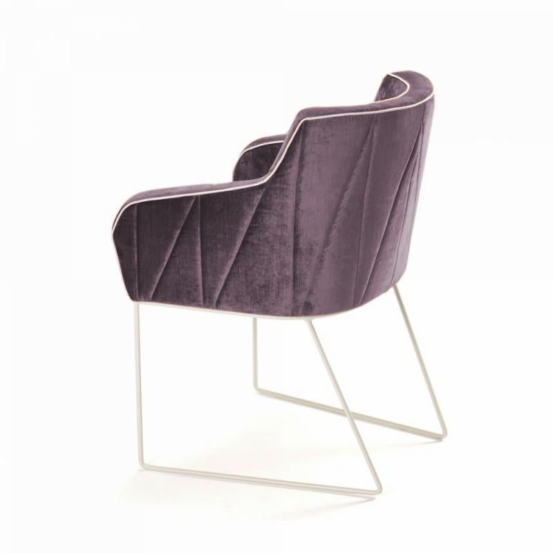 Delicate seaming in diagonal shapes throughout Croix upholstered back contrast with the smooth seating. Stylish and elegant, this armchair is extremely comfortable in its’ perfect finishing’s. With each fabric and metal base lacquer combination it