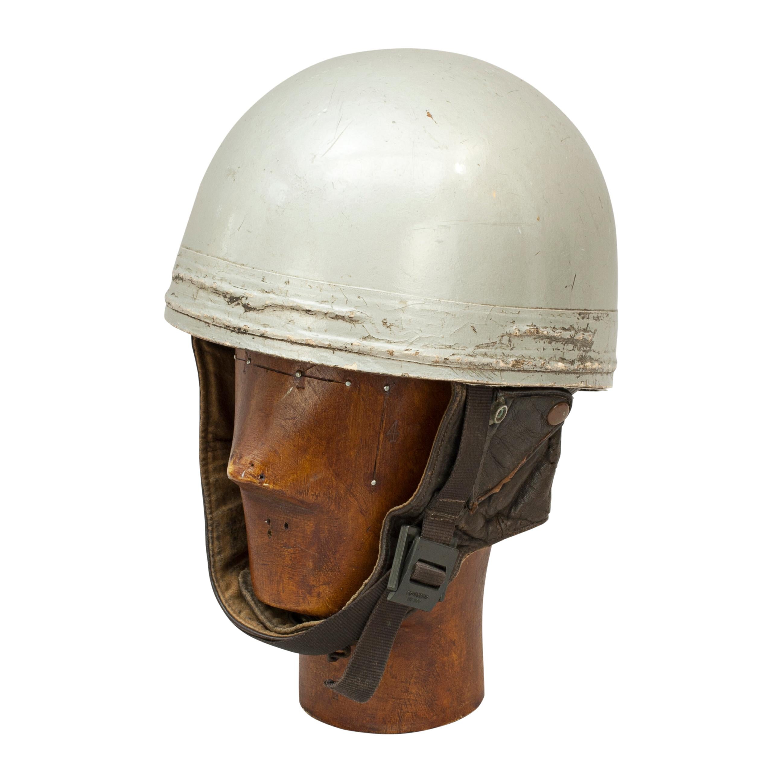 A.C.U approved Cromwell racing motorcycle crash helmet.
A silver painted motorcycle, pudding basin shape helmet made in England by Cromwell. This helmet has a cork interior, fitted with a fabric headband and straps keeping a space between the head