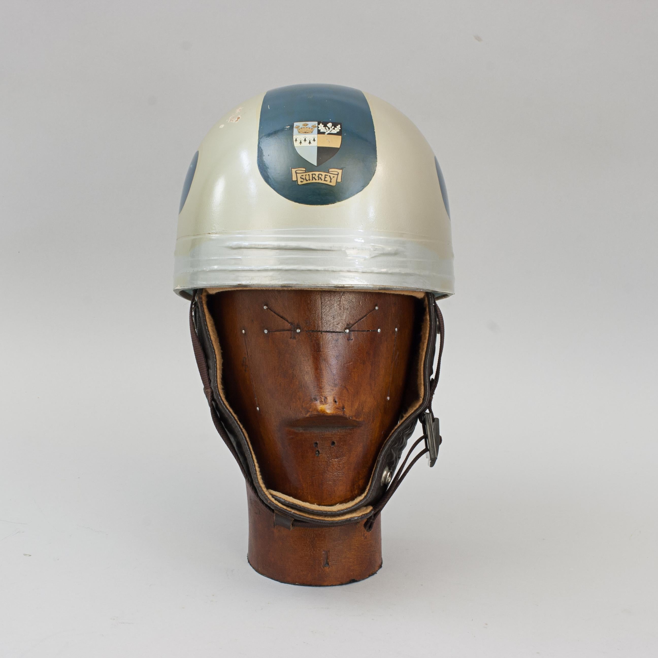 Vintage Cromwell Motorcycle Crash Helmet.
A fine motorcycle, pudding basin shaped helmet made in England by Cromwell. The helmet with silver and blue paint with the words 'Surrey' and the old coat of arms for the county of Surrey. It has a cork