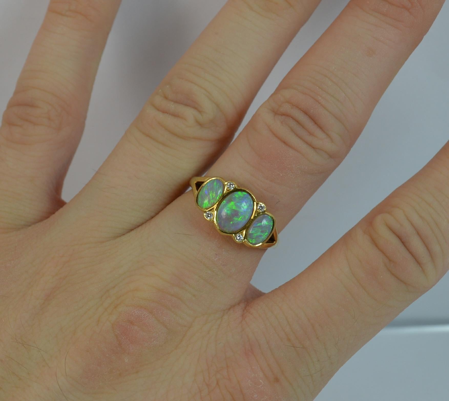 
A beautiful vintage 18 carat gold, opal and diamond ring in the Victorian design.
​
​The 18 carat yellow gold shank and setting.

Designed with three oval opals, all natural and full of colour. Pairs of VS diamond spacers in between.

15mm x 9mm