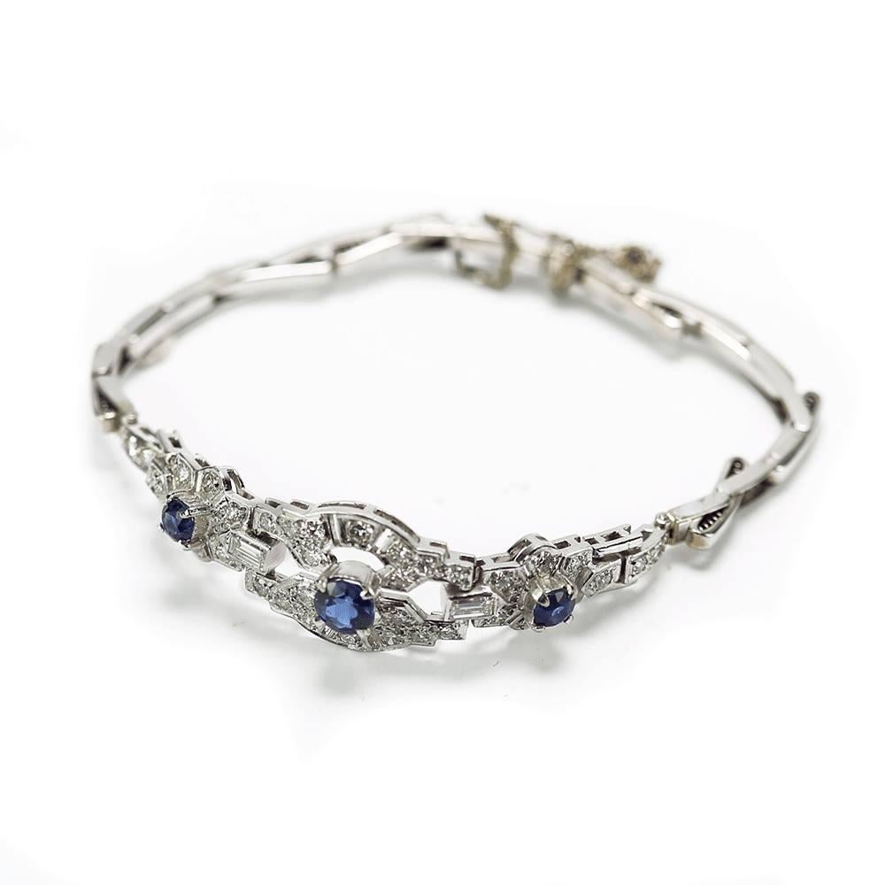 A superb vintage English Cropp & Farr bracelet, set in 18ct white gold with three principle blue sapphires (est. centre 0.40cts, flanked by two 0.15cts) with pavé eight-cut diamonds 0.34cts and two baguette cut diamonds est. 0.22cts. total weight