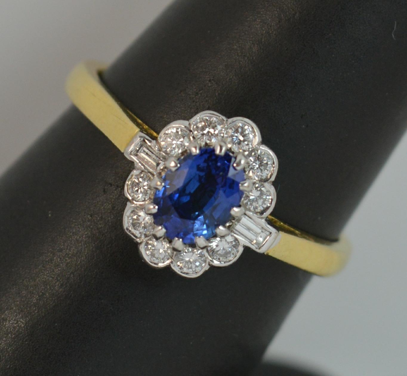 A stunning antique shaped Cropp and Farr designer cluster ring.
SIZE ; Q UK, 8 US
18 carat yellow gold shank with white gold head setting.

Designed with a fantastic quality oval cut sapphire to centre, 4.6mm x 5.9mm approx. Surrounding are ten