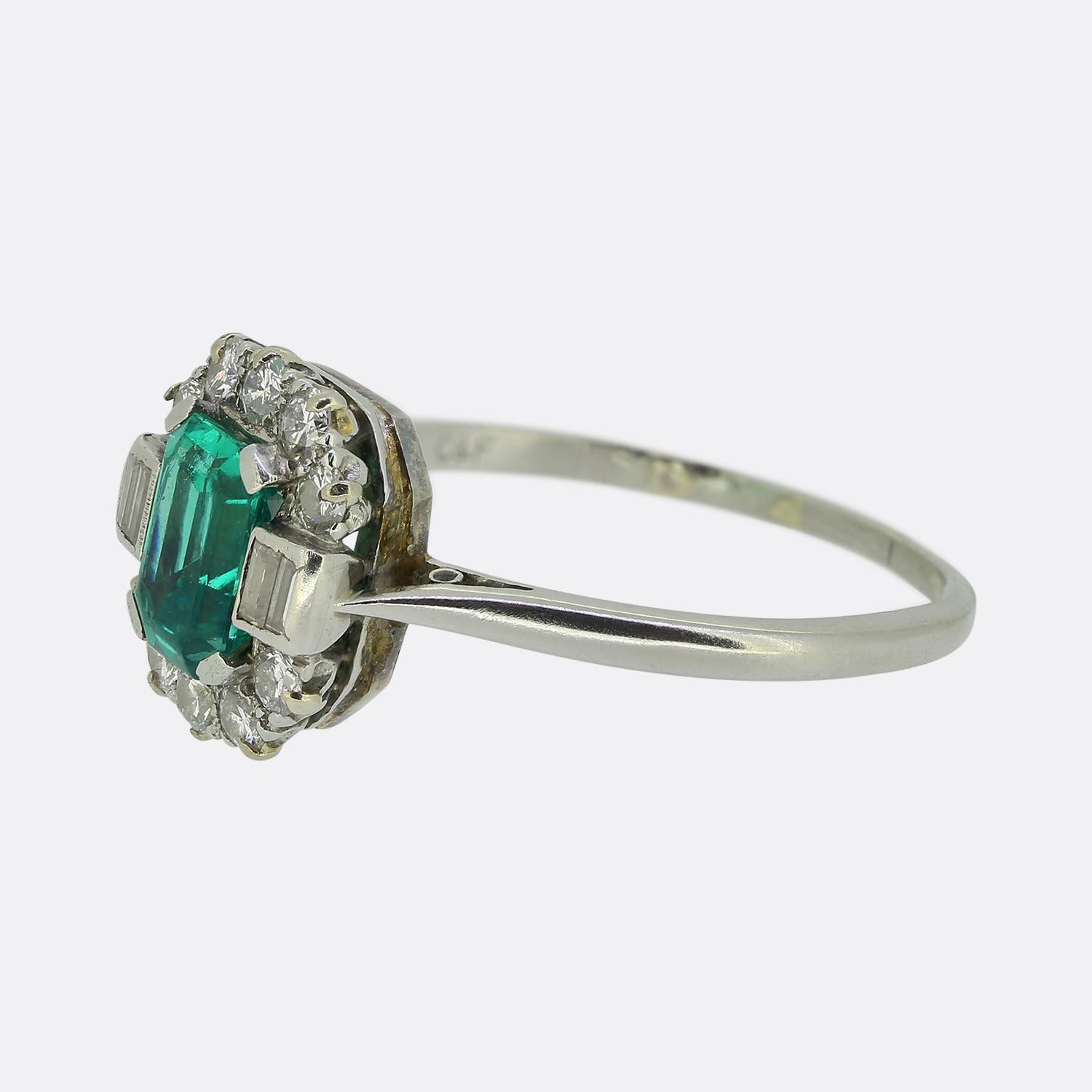 Here we have a striking Art Deco ring from the iconic early 20th century London based jewellery designer, Cropp & Farr. This charming piece focally features a captivating green emerald-cut emerald at its centre which is flanked on either side by a