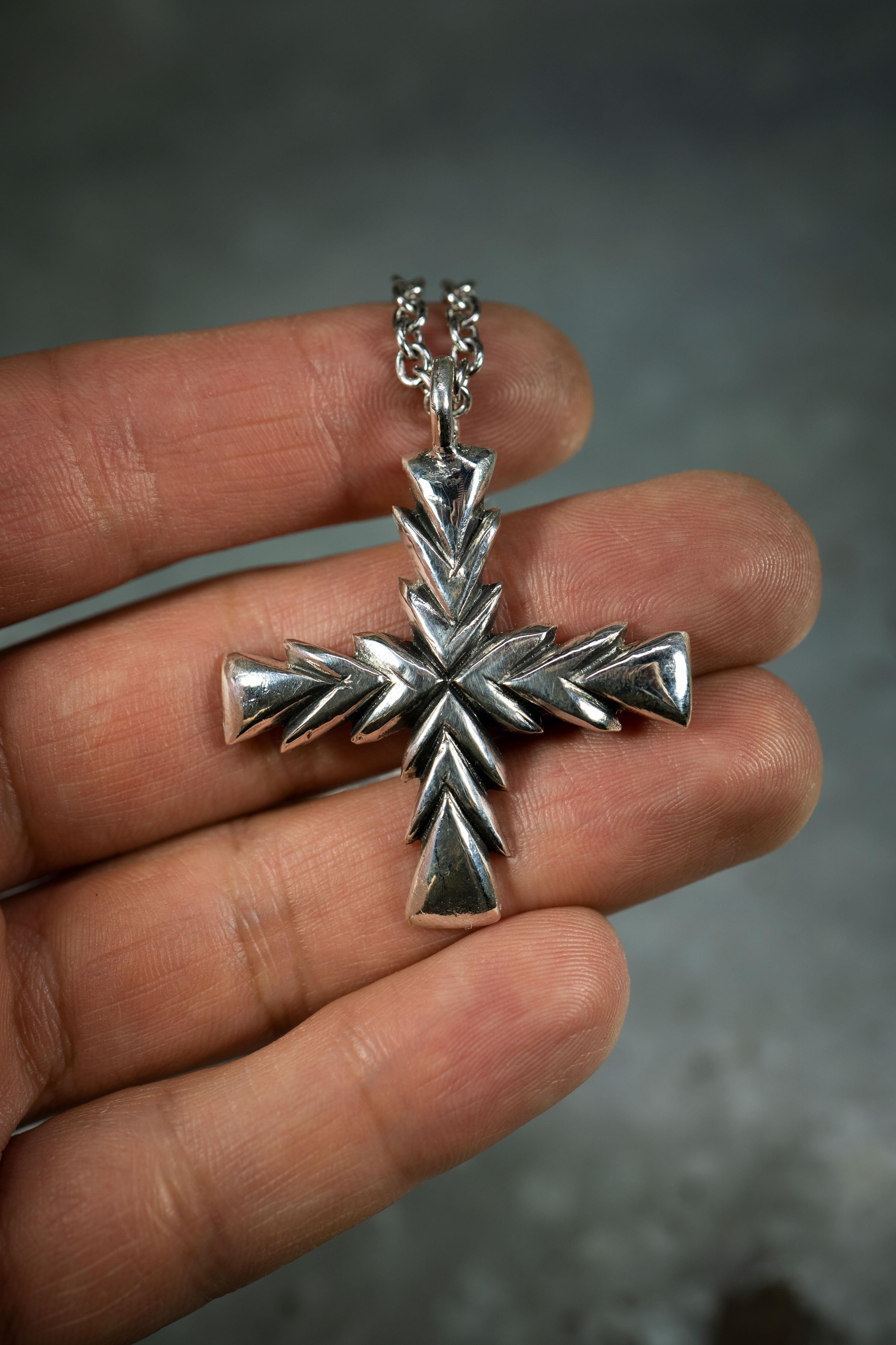 Ken Fury's original version of the cross pendant is a striking and meaningful piece of wearable art that is hand-carved and cast. The cross has a rich history that spans across many cultures and religions around the world, and this piece pays homage