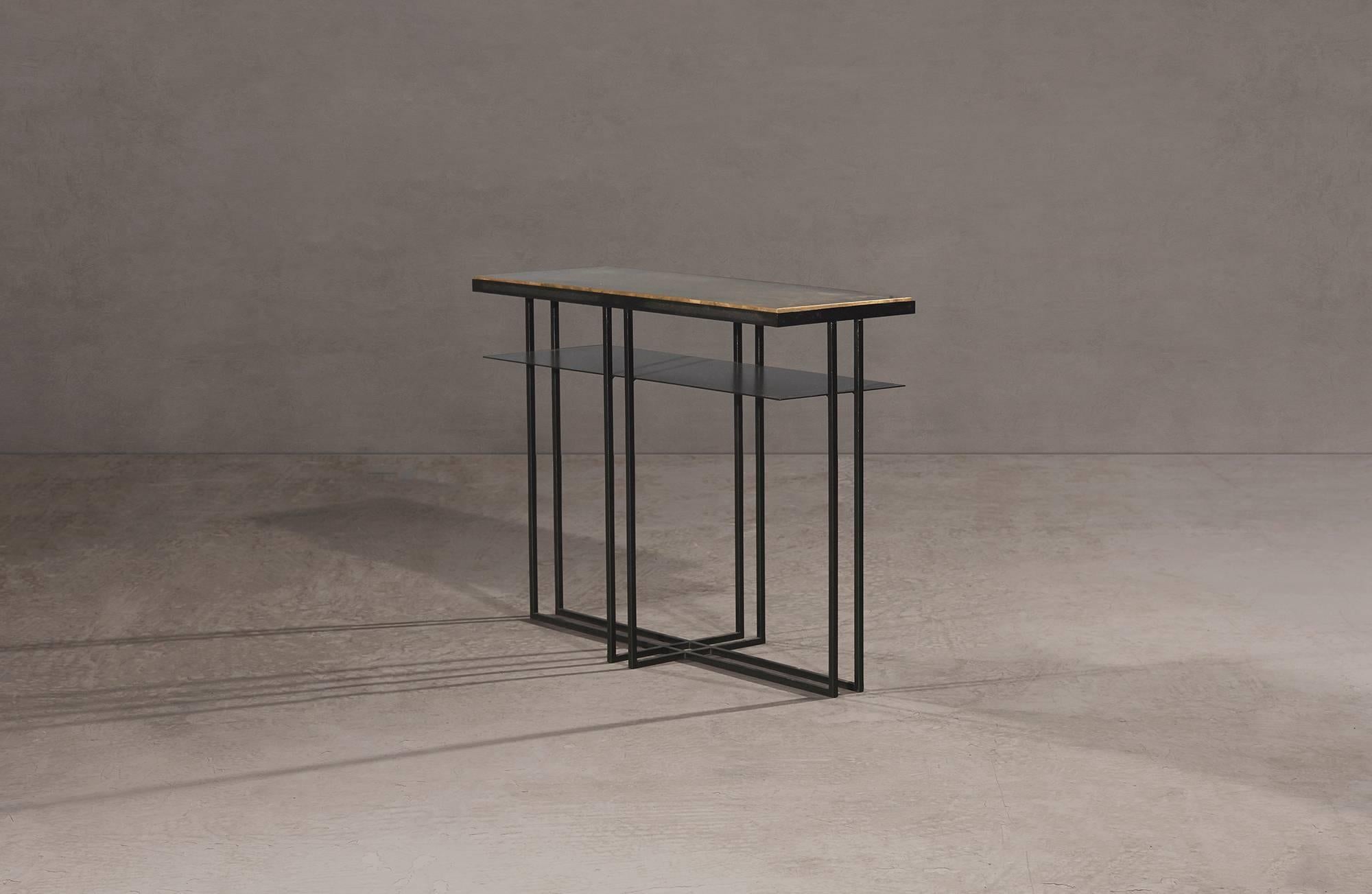 A side table in blackened steel and patinated brass, with a polished brass trim. Hand crafted in the North to order. Custom sizes and finishes are available.

Measures: 71cm (length) x 25cm (width) x 55cm (height). 
Custom sizes