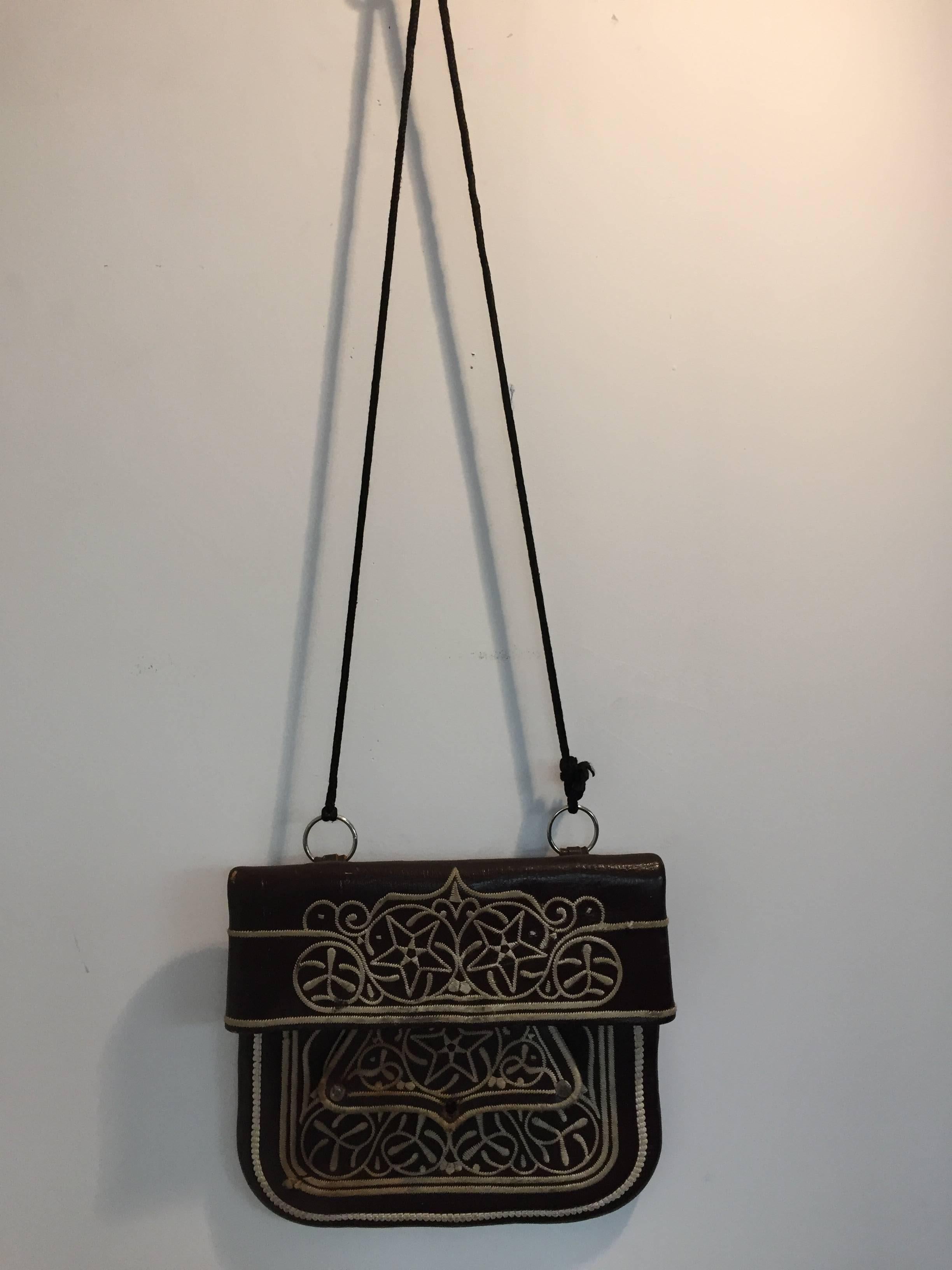 vintage ethnic Berber hand tooled and embroidered
leather satchel shoulder cross body bag.
Handcrafted by the Berber artisans from the Rif Mountains in North Morocco Africa. 
Great Moroccan ethnic collectible folk art.