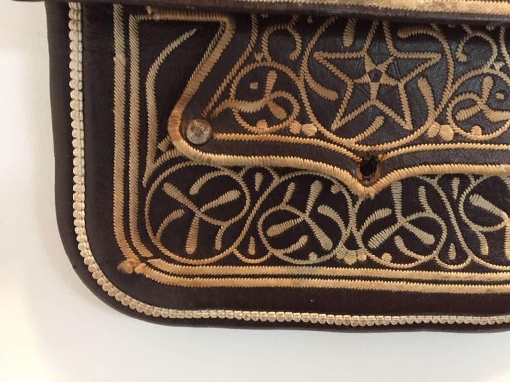 vintage ethnic Berber tribal hand tooled and embroidered
leather satchel shoulder cross body bag.
Handcrafted by the Berber artisans from the Rif Mountains North Morocco Africa. 
Great Moroccan folk art.
