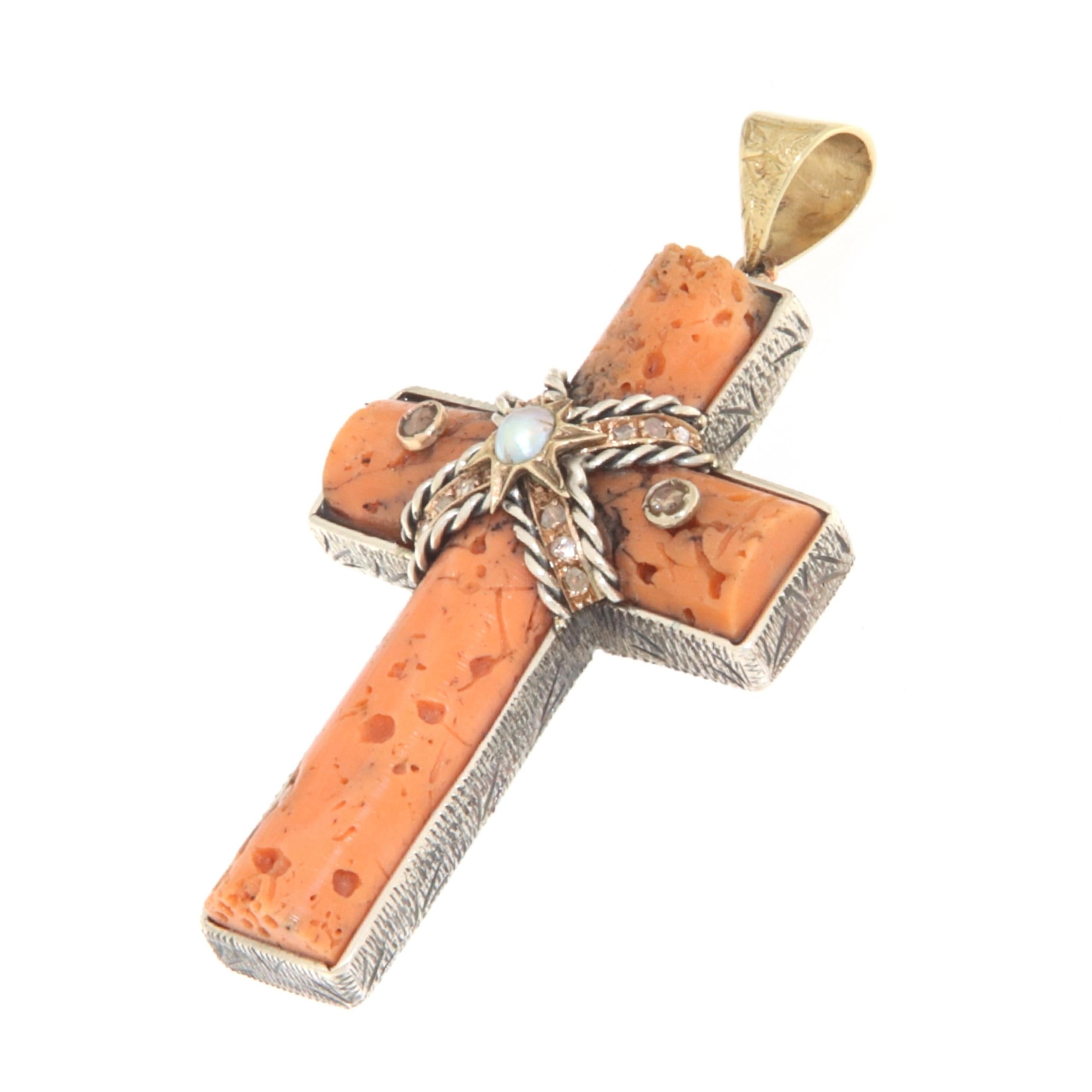 This antique cross pendant is a captivating and historically rich piece, skillfully blending precious materials and significant details. Crafted in 9-karat yellow gold and 800-millesimal silver, this cross features a classic design enriched with