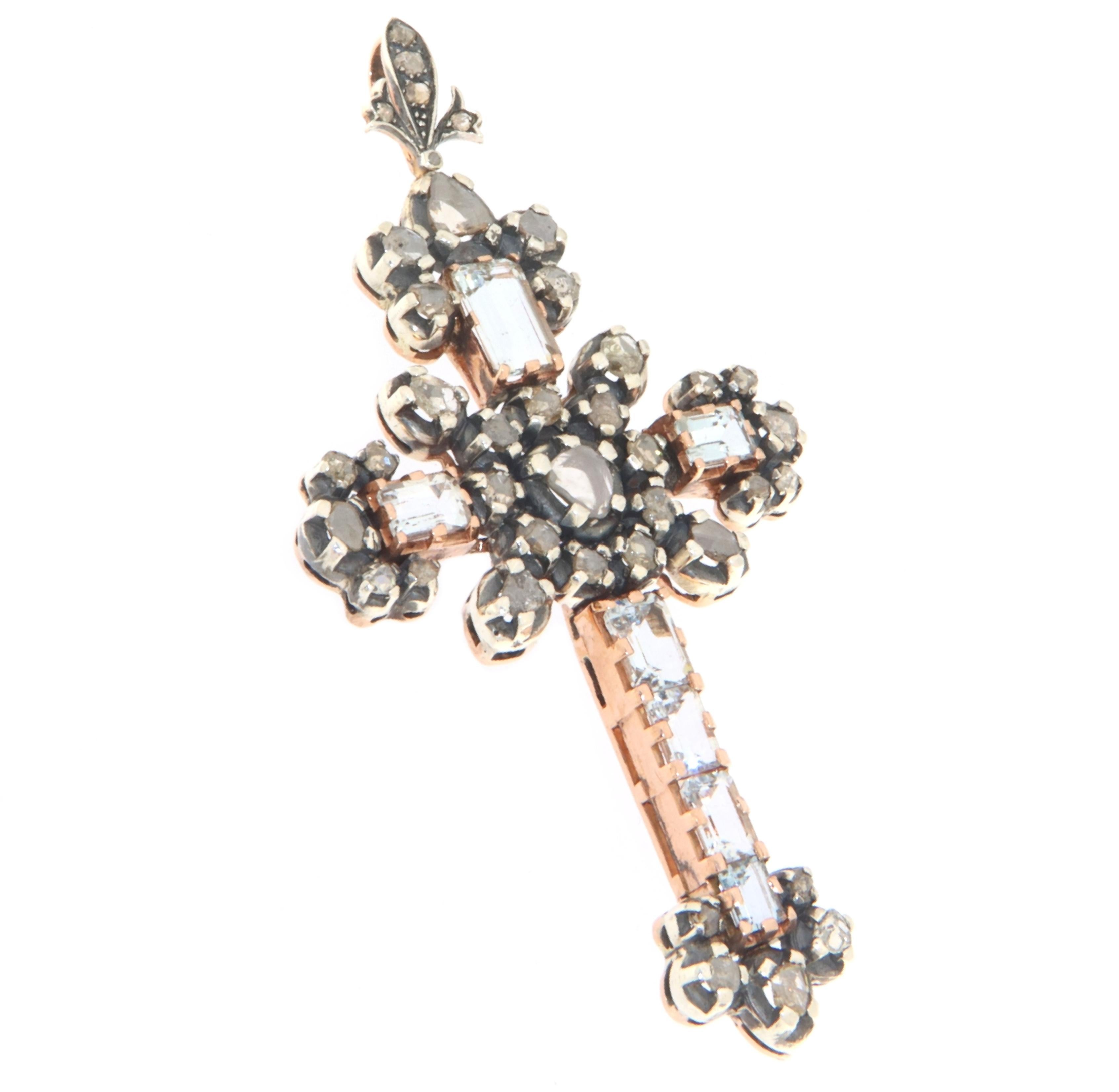 The beauty of tradition and the richness of detail converge in this splendid cross pendant from the 1900s. Crafted in 9-karat yellow gold and 800-millesimal silver, this cross is a tribute to the savoir-faire of yesteryear's goldsmiths. Skillfully