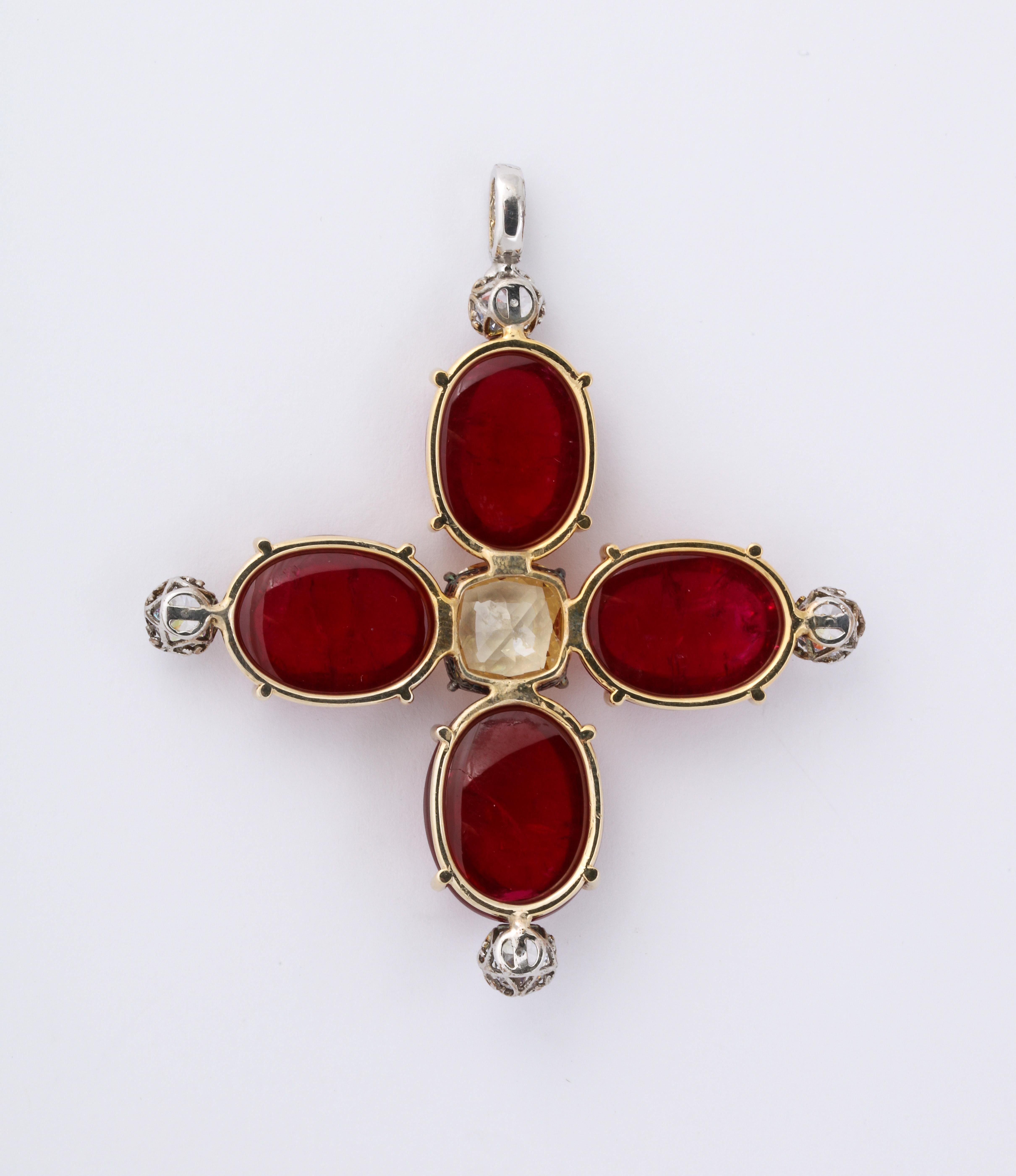 Man Made Cabochon Ruby Yellow Sapphire Gold And Sterling Cross Pendant.
Perfect color large, nearly 1 inch, man made cabochon rubies set in 14kt yellow gold centering a faux yellow sapphire tipped with CZ accents. Pendant cross measures 3inches by