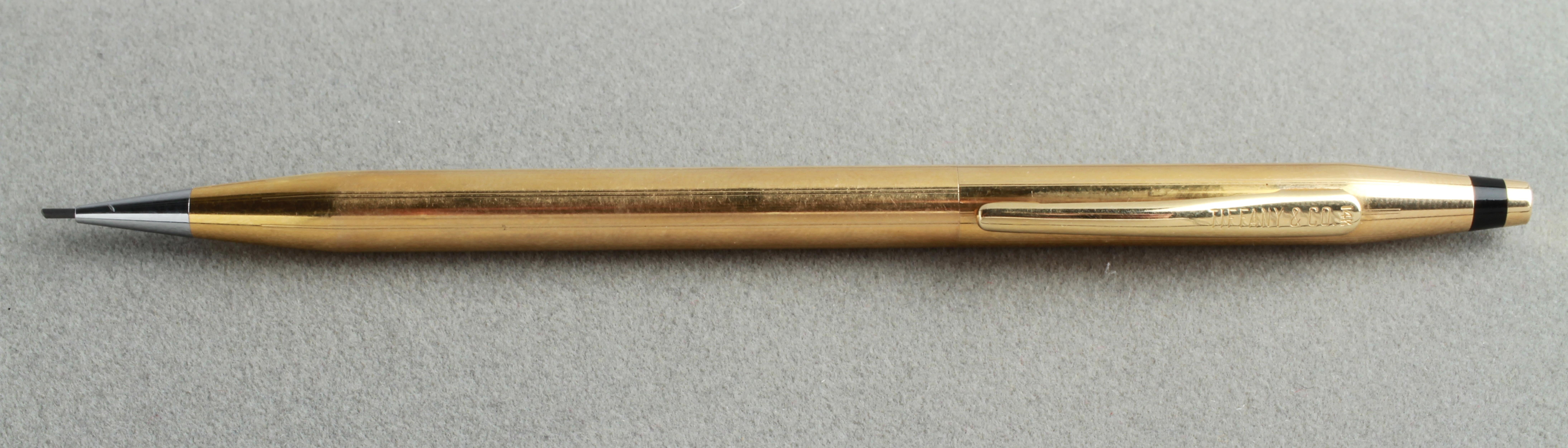 Modern mechanical pencil designed by Cross for Tiffany & Co. in 14-karat yellow gold. Approximately 13.8 dwt inclusive. The piece is in great vintage condition with age appropriate wear and a small dent. 
From the Estate of Elliott Lang.
  