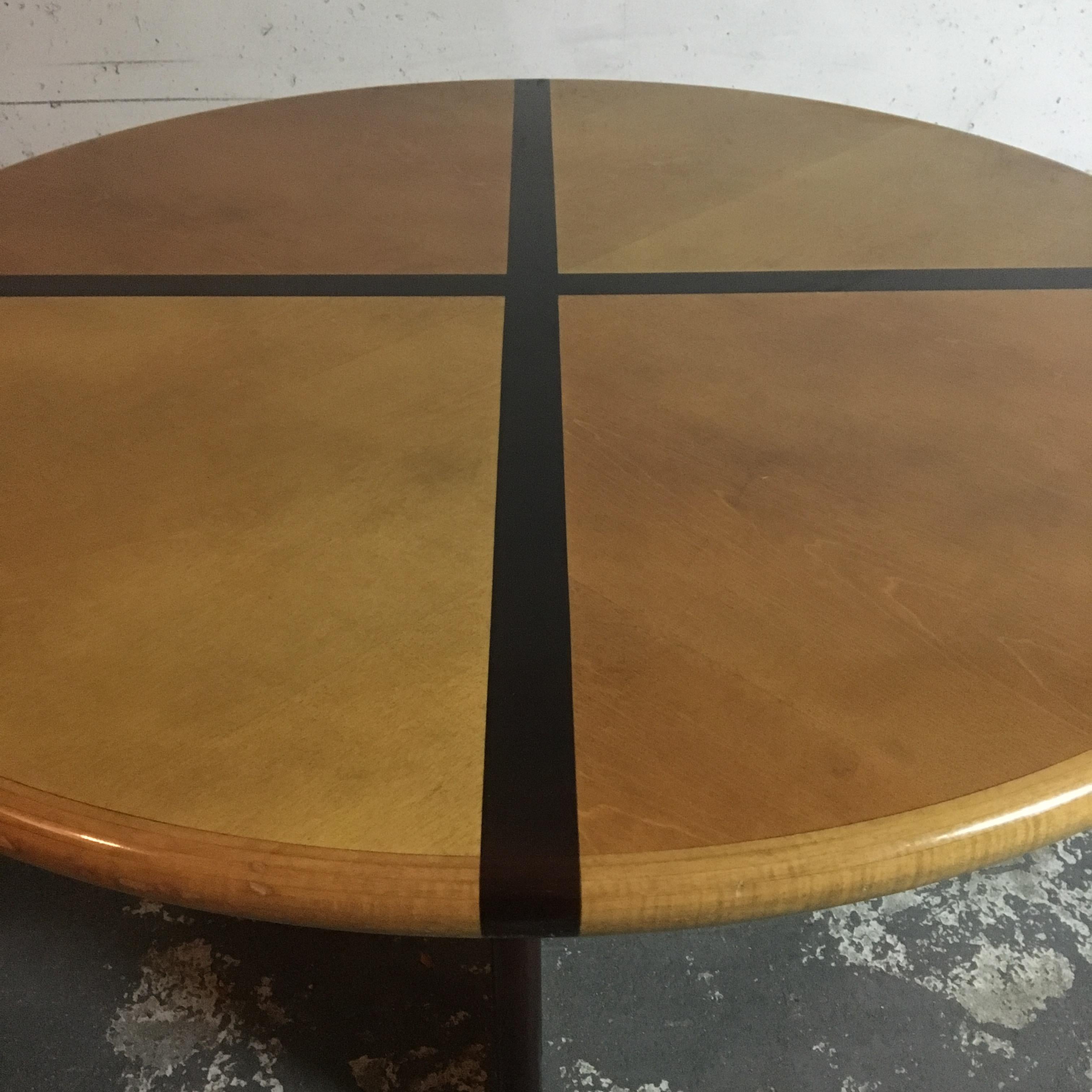 A very original French round table produced in France during the 1970s. The table is designed for 4 people, given the division that results from the structure of her legs. A kind of cross on the top side of the table which continues downward through