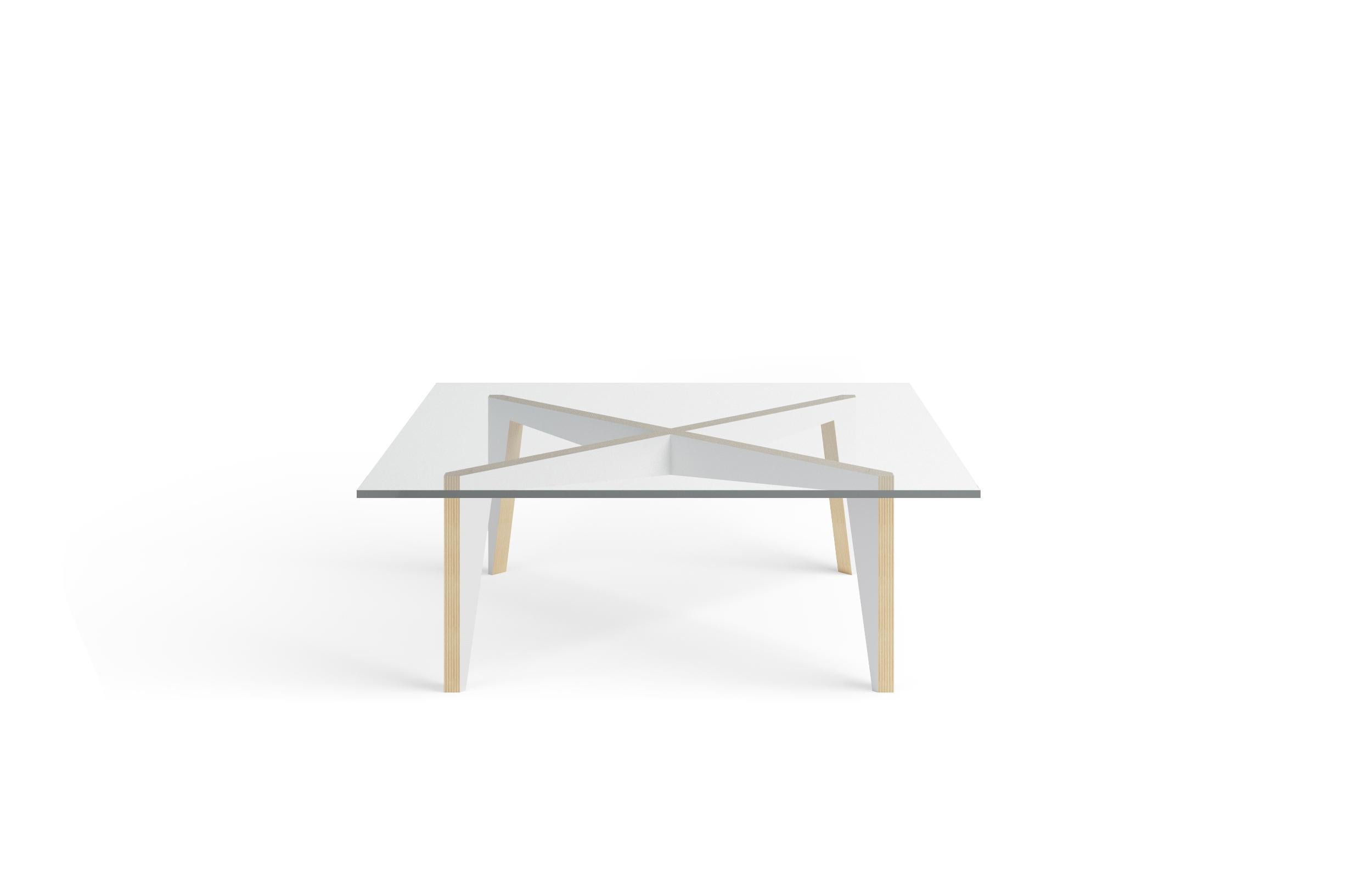 This minimalist coffee table has a furniture-grade plywood base and a glass top. The precision joinery makes assembly painless while the silhouette of the cross-shaped base with its subtle geometry captures the tension between movement and