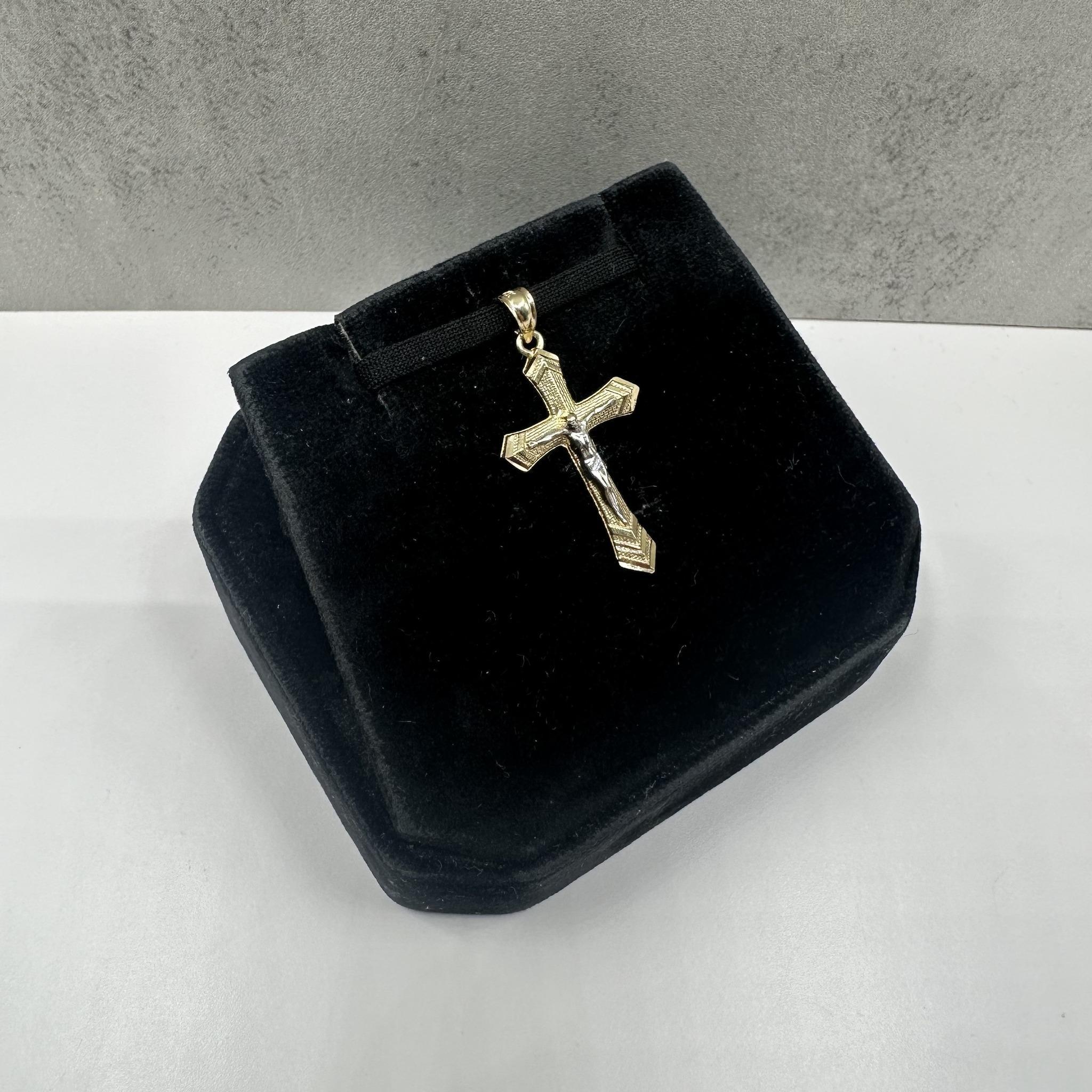 This classic cross pendant in 14kt yellow gold offers a timeless and elegant look that symbolizes faith and devotion. Crafted with a polished finish, it provides a radiant shine that complements any style. Weighing 0.91 grams with inner bail