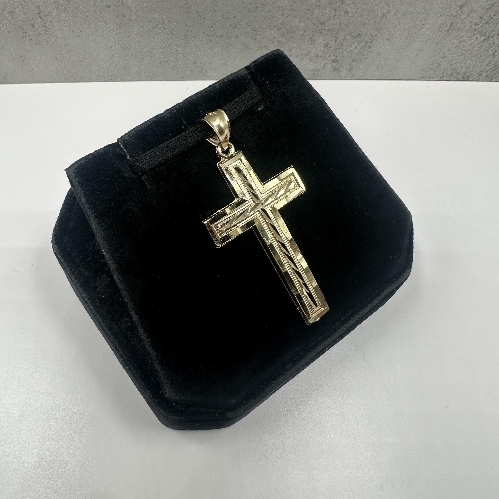 This classic Cross Pendant in 14kt yellow gold features a timeless design perfect for daily wear. Weighing 2.62 grams, it is lightweight yet substantial for comfortable wear. The inner bail measures approximately 5.8x4.9mm, fitting most small