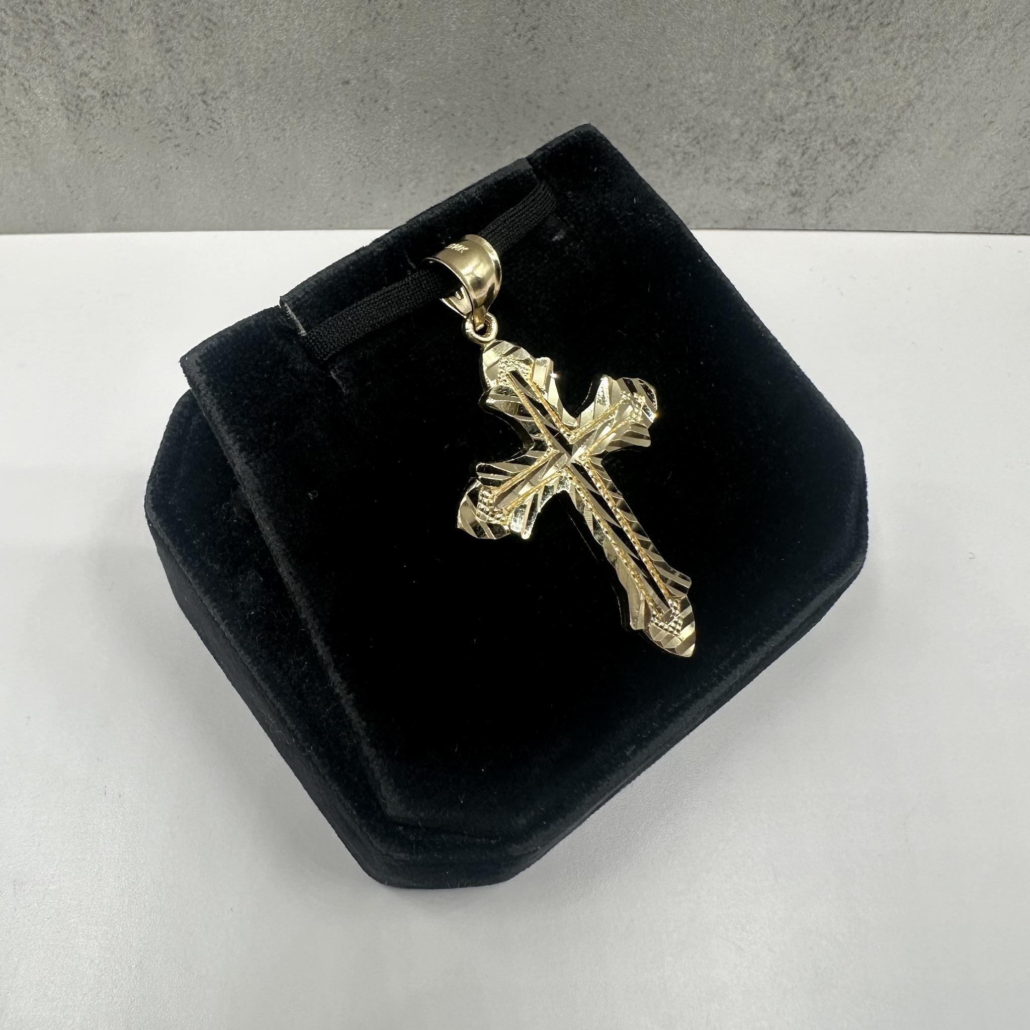 This classic Cross Pendant in 14kt yellow gold features a polished, timeless design perfect for daily wear. Weighing 3.32 grams, it offers a substantial feel without being heavy. The inner bail measures approximately 6.6x6mm, allowing it to fit most