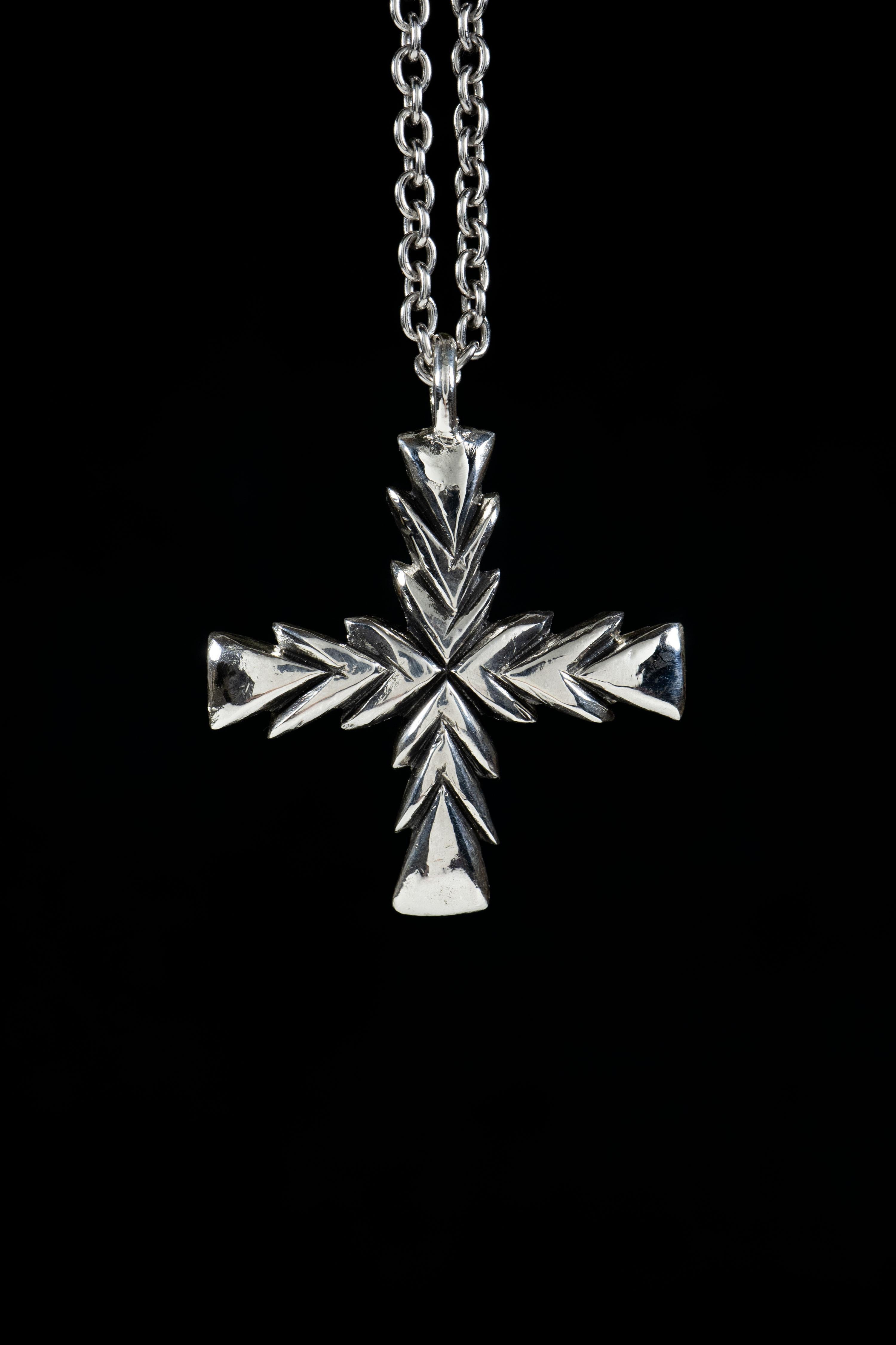 Ken Fury's original version of the cross pendant is a striking and meaningful piece of wearable art that is hand-carved and cast. The cross has a rich history that spans across many cultures and religions around the world, and this piece pays homage