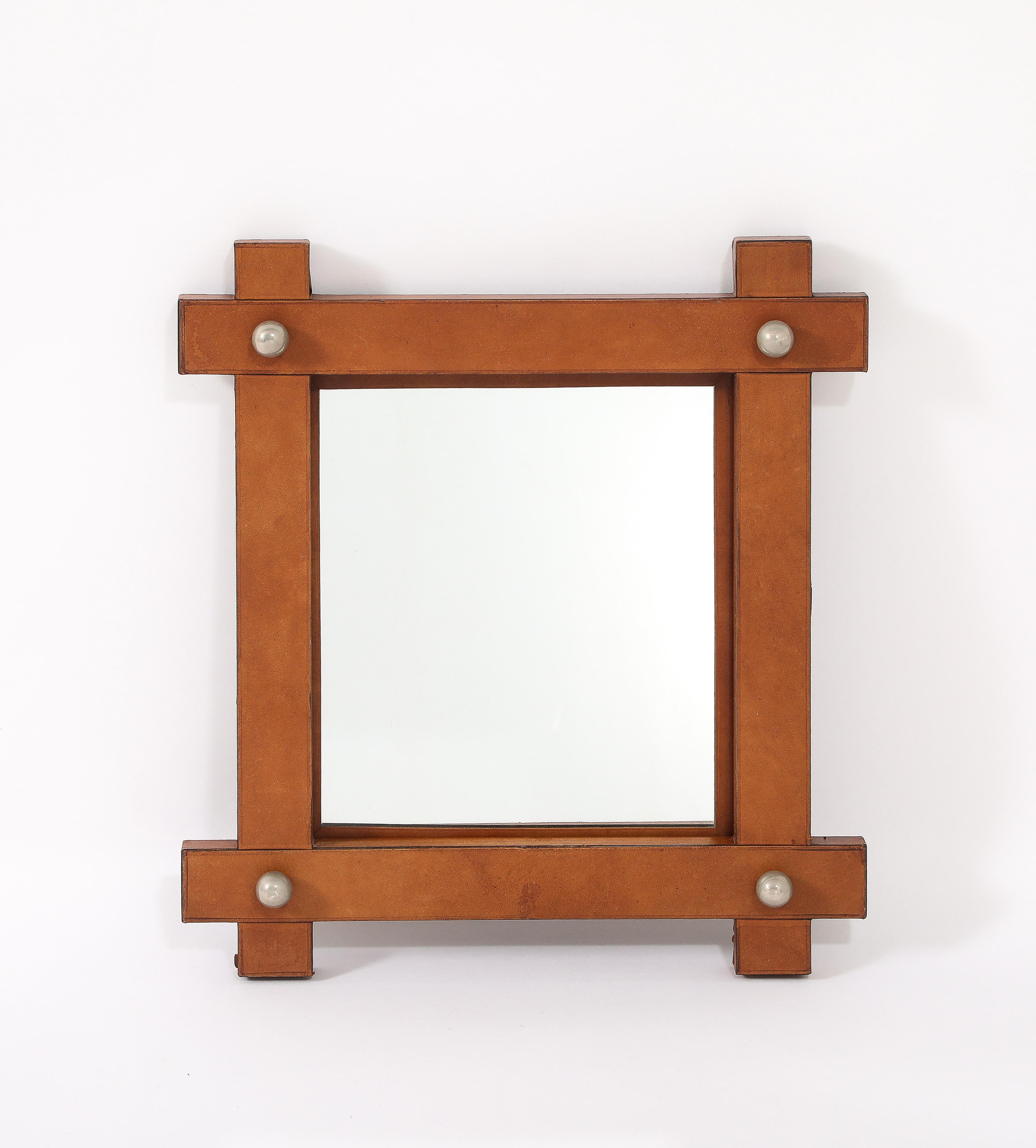 A simple yet elegant leather-wrapped mirror with burnished nickel hardware.