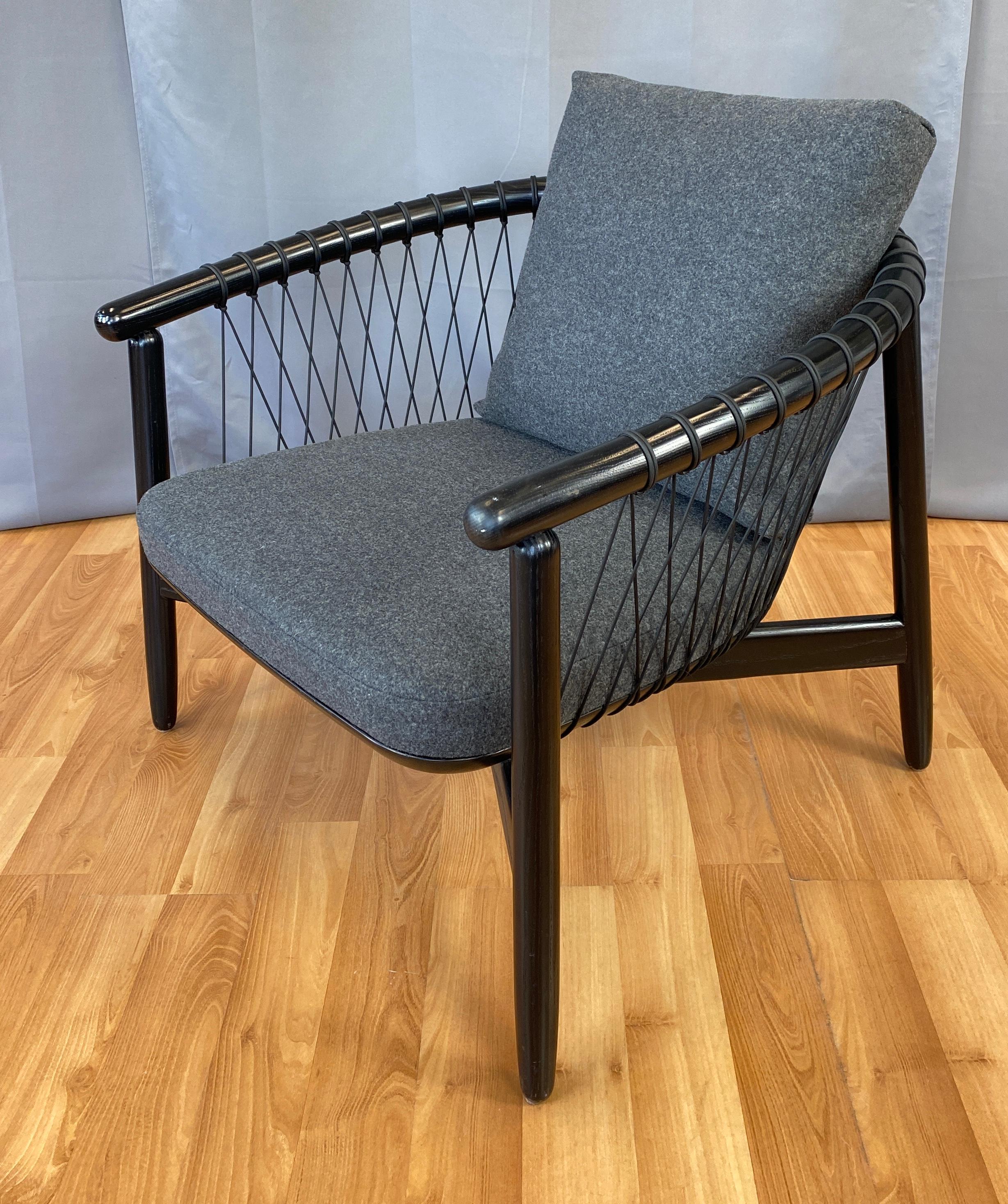 Offered here is a Crosshatch chair designed by Eoos for Geiger a Herman Miller company.
Frame and parachute cords are black, upholstery is a grey/black wool.

From Herman Miller's web site: 
The feeling of being enveloped in a protective nest