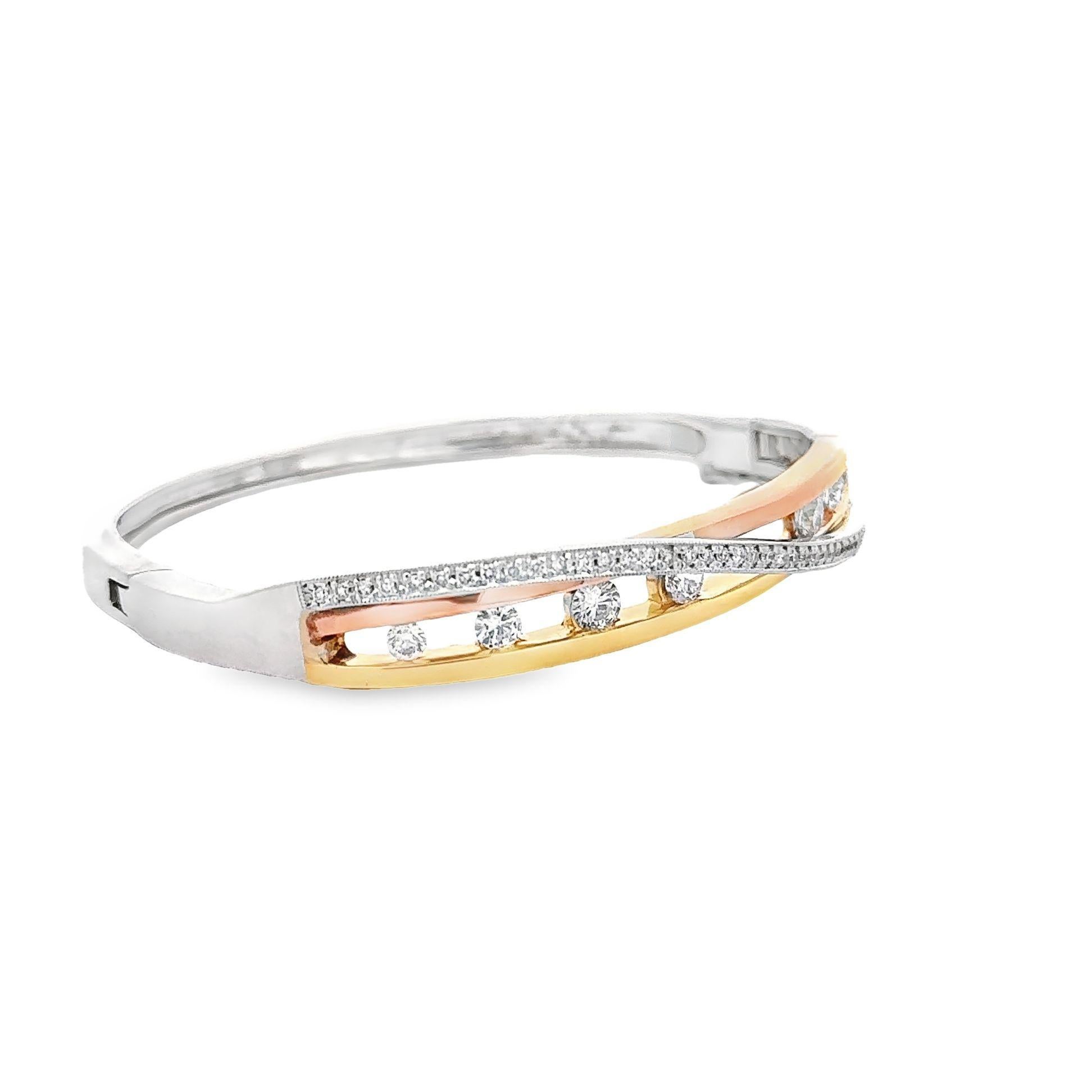 This three color gold & diamond bangle is a sweet addition to your daily outfit. The rigidness of the bracelet in yellow, white and pink gold features a smooth and polished elegance. Embraced by the parting and overlapping ribbons are pave-set