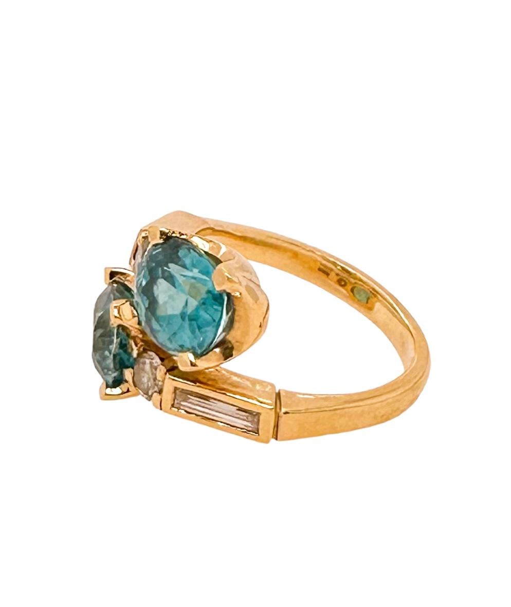 Crossover Blue Zircon ring, total weight of zircons - 7.57ct with baguettes and brilliant diamonds set in 18ct yellow gold ring.

This ring is a showstopper and a part of Esther's 'Vine Leaf and Flora' collection, inspired by a previous Roman
