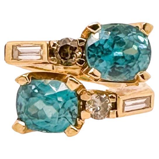 Crossover Blue Zircon Ring - 18ct yellow gold with diamonds For Sale