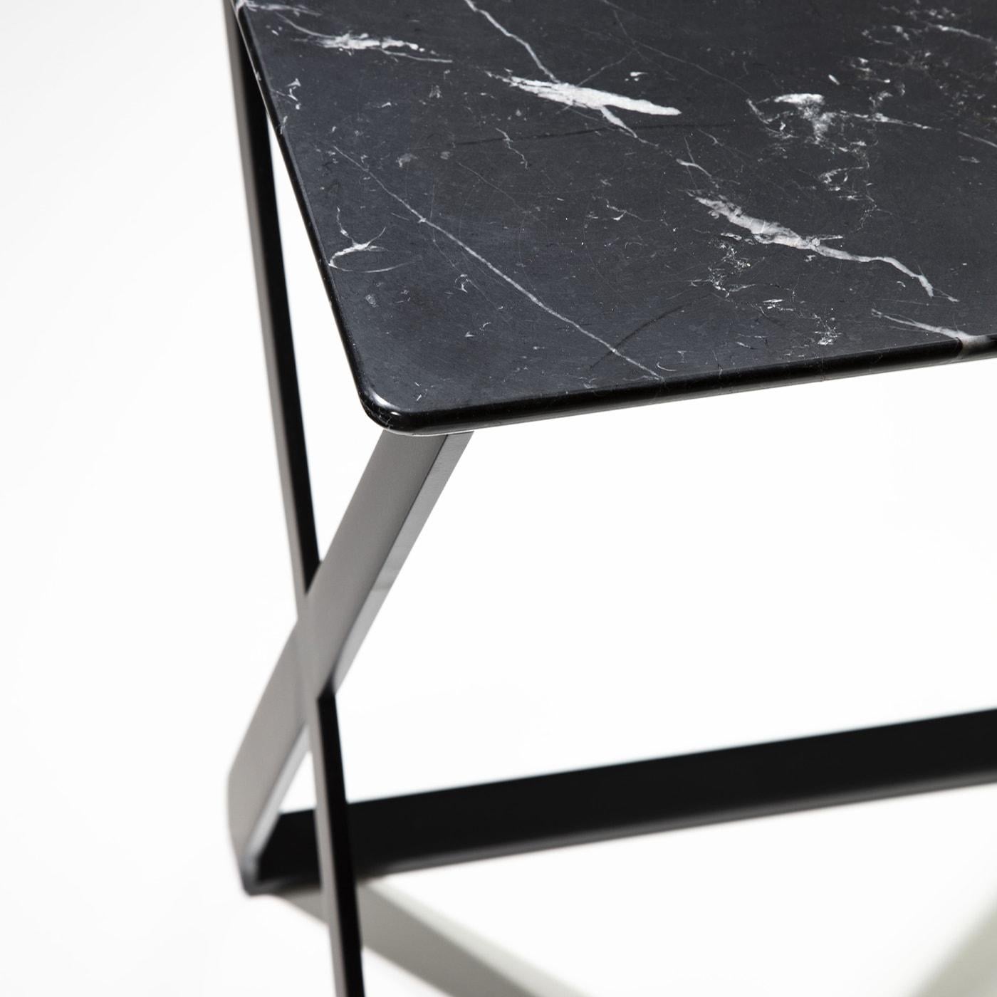 Side table with x-shaped structure painted in matt black. Top in Nero Marquinia marble. Please, contact us for further information and options.
  